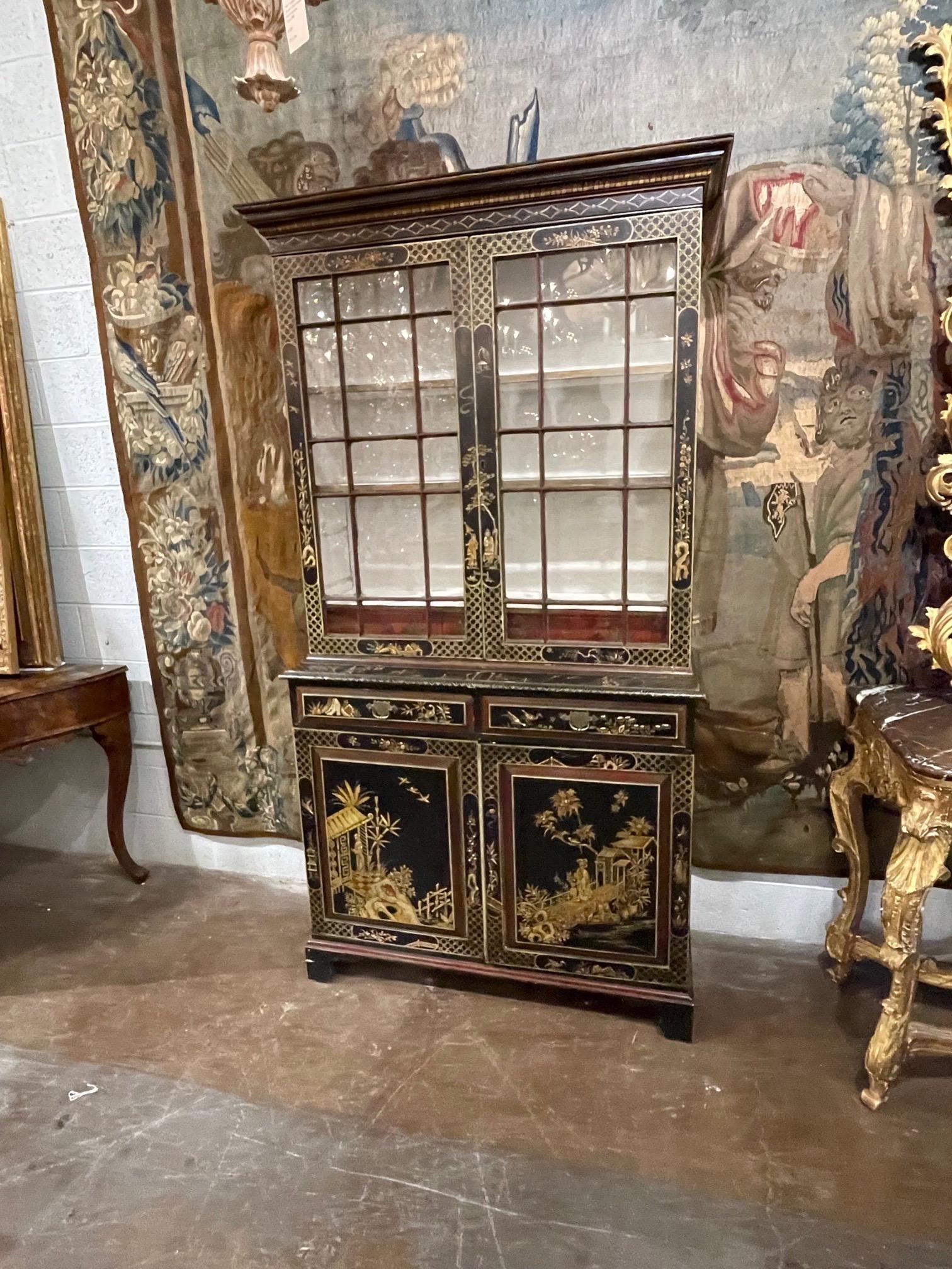 Beautiful decorative 19th century black lacquered bookcase with raised Chinoiserie design. Features interesting Asian designs. A true work of art!