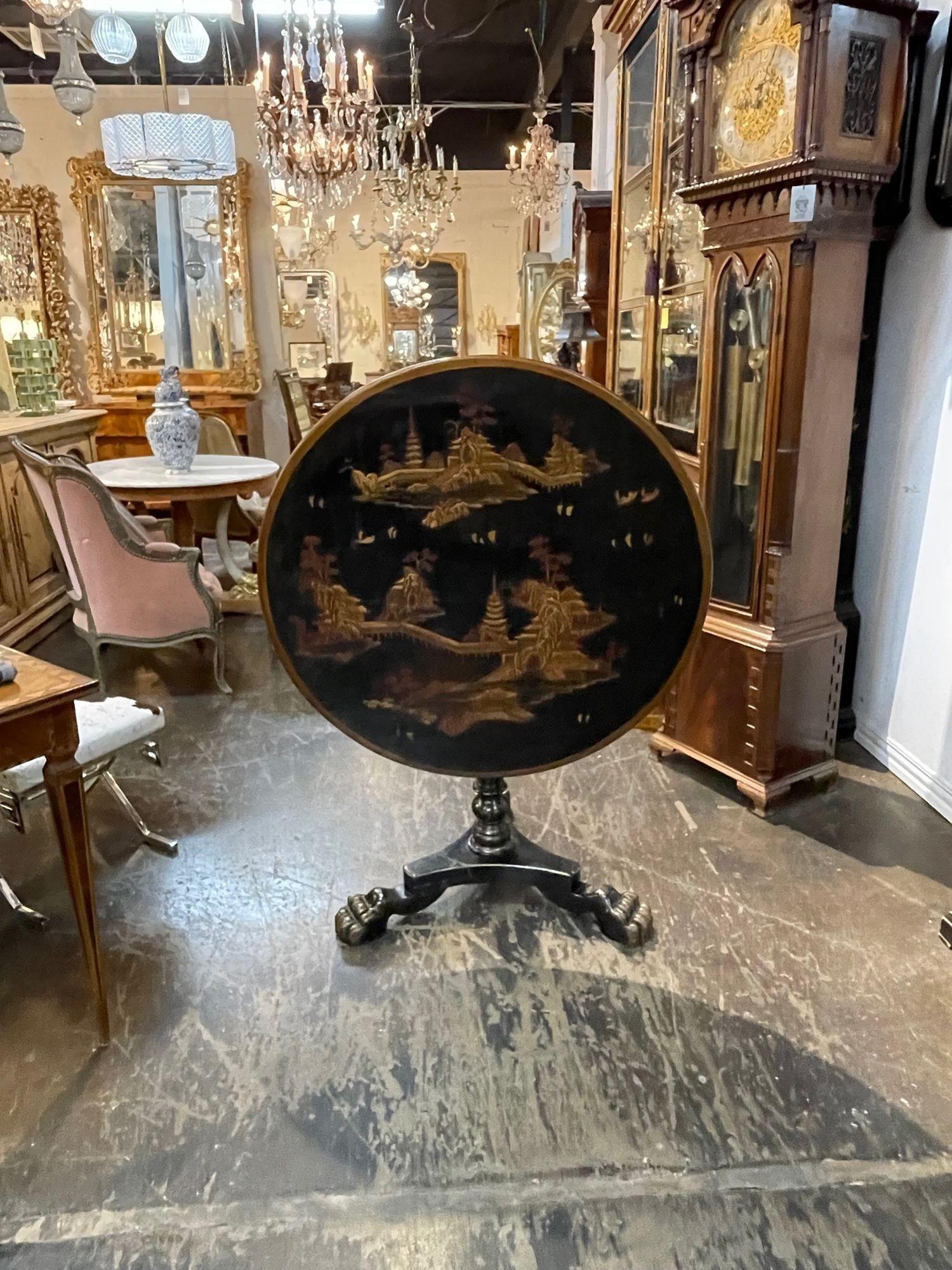 Exqusite 19th century English black lacquered tilt top table with Chinoiserie design. Gorgeous hand painted Asian images. A true work of art. Stunning!!