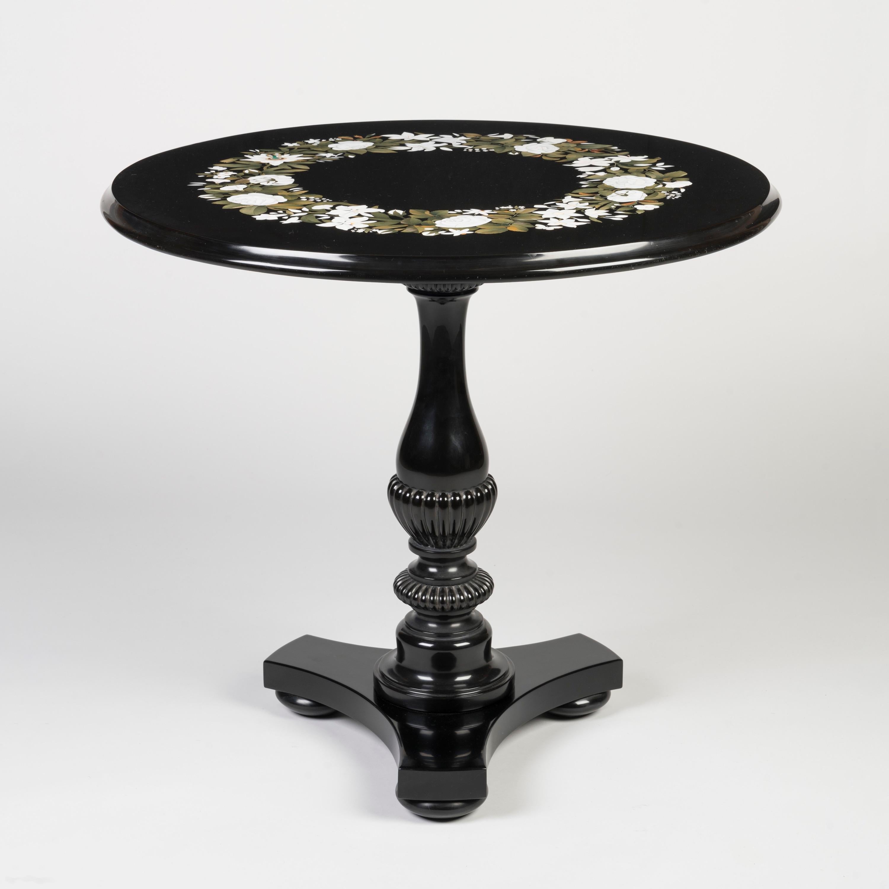 An English Black Marble & Pietra Dura Table
By Thomas Woodruff

'Inlayer to the Queen'

A superb pedestal table of refined proportions and design, constructed entirely from black Ashford marble, the circular top inlaid with a floral wreath executed