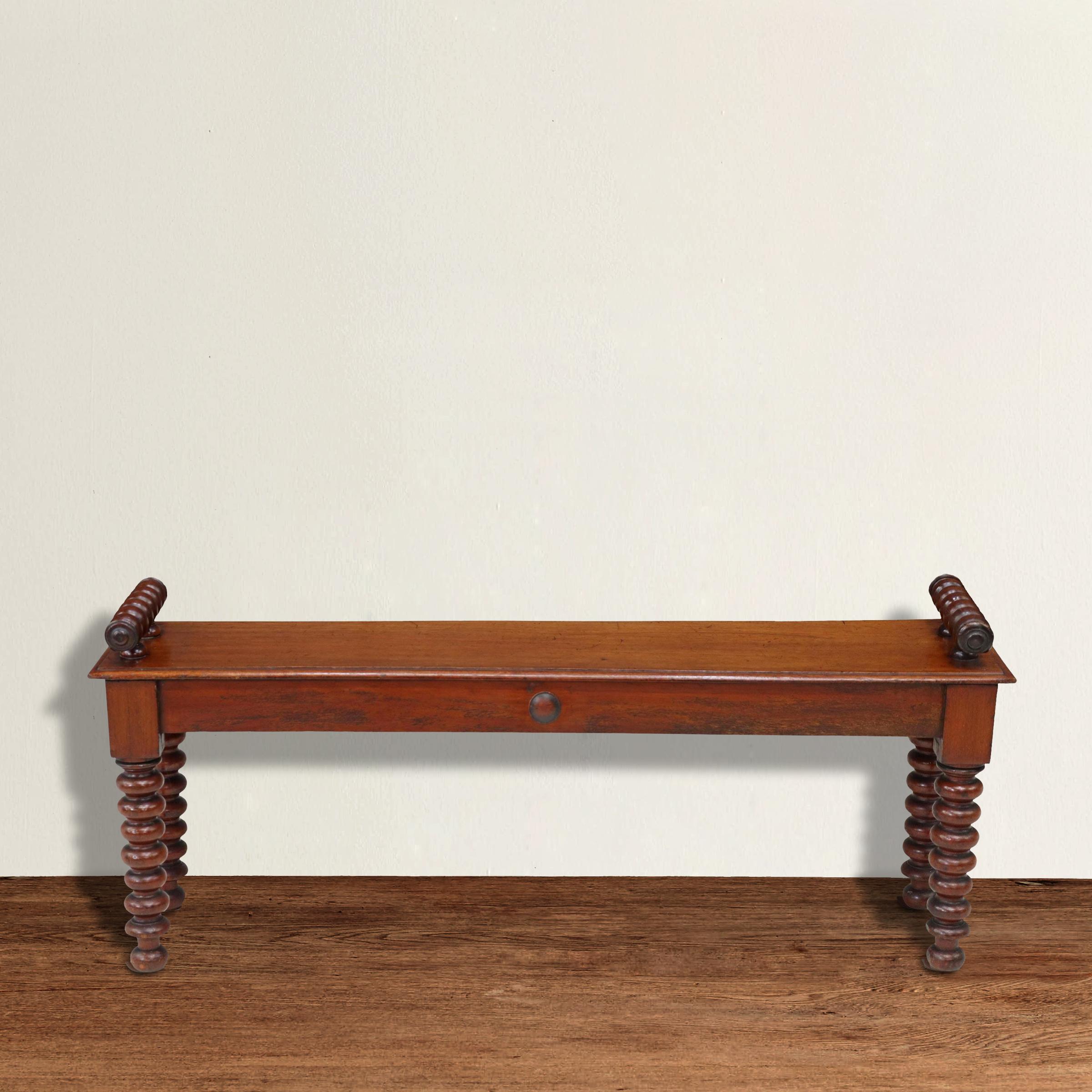 A quirky yet elegant 19th century English mahogany hall bench with the best turned 
