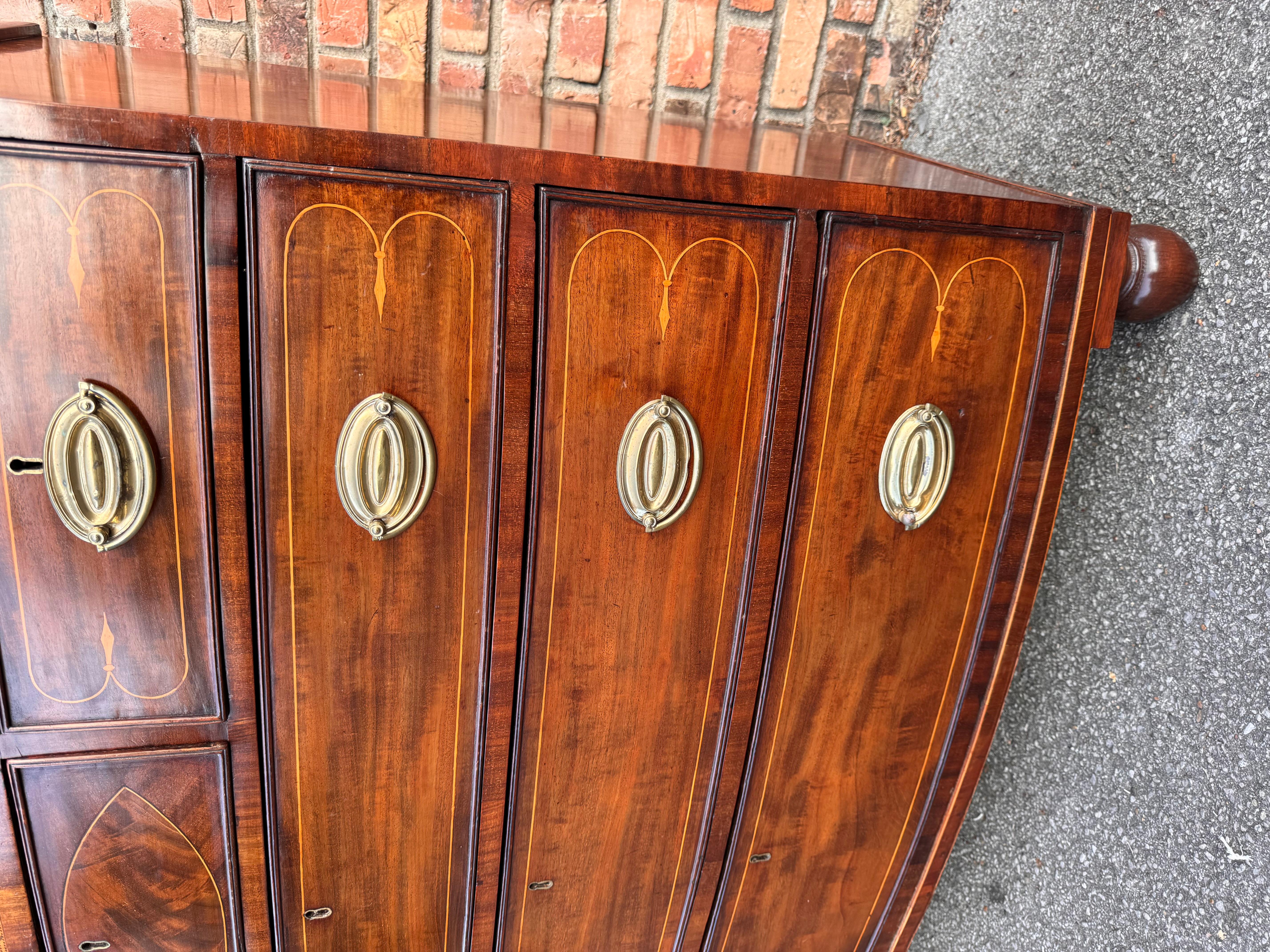 This is an absolutely stunning 19th century English bow front chest. The beautiful string inlay is so amazingly done it's been recently French polished which gives it such an amazing glow. The wood is a flamed mahogany. Especially like the