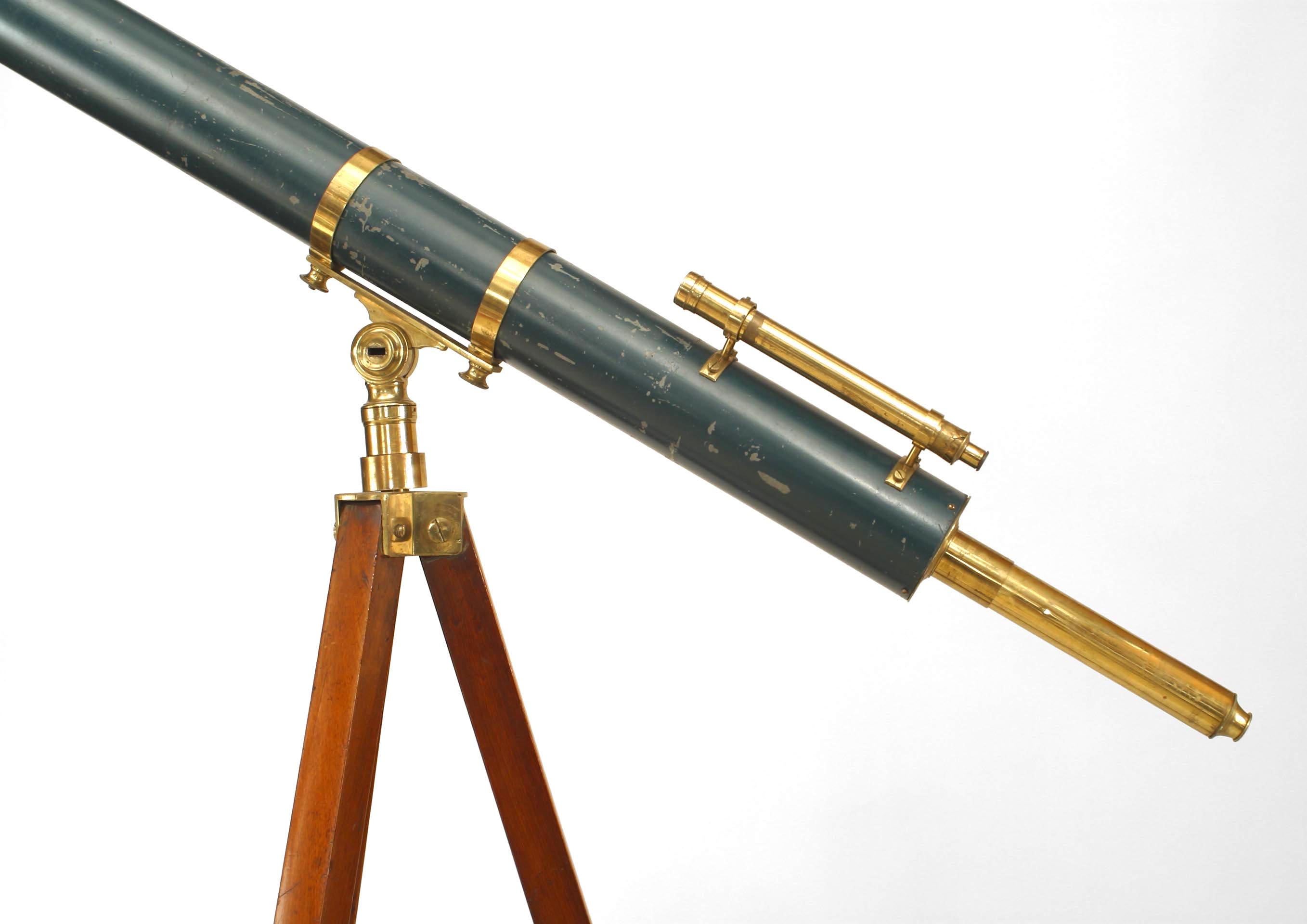 English Victorian brass and blue telescope on adjustable mahogany tripod base.
