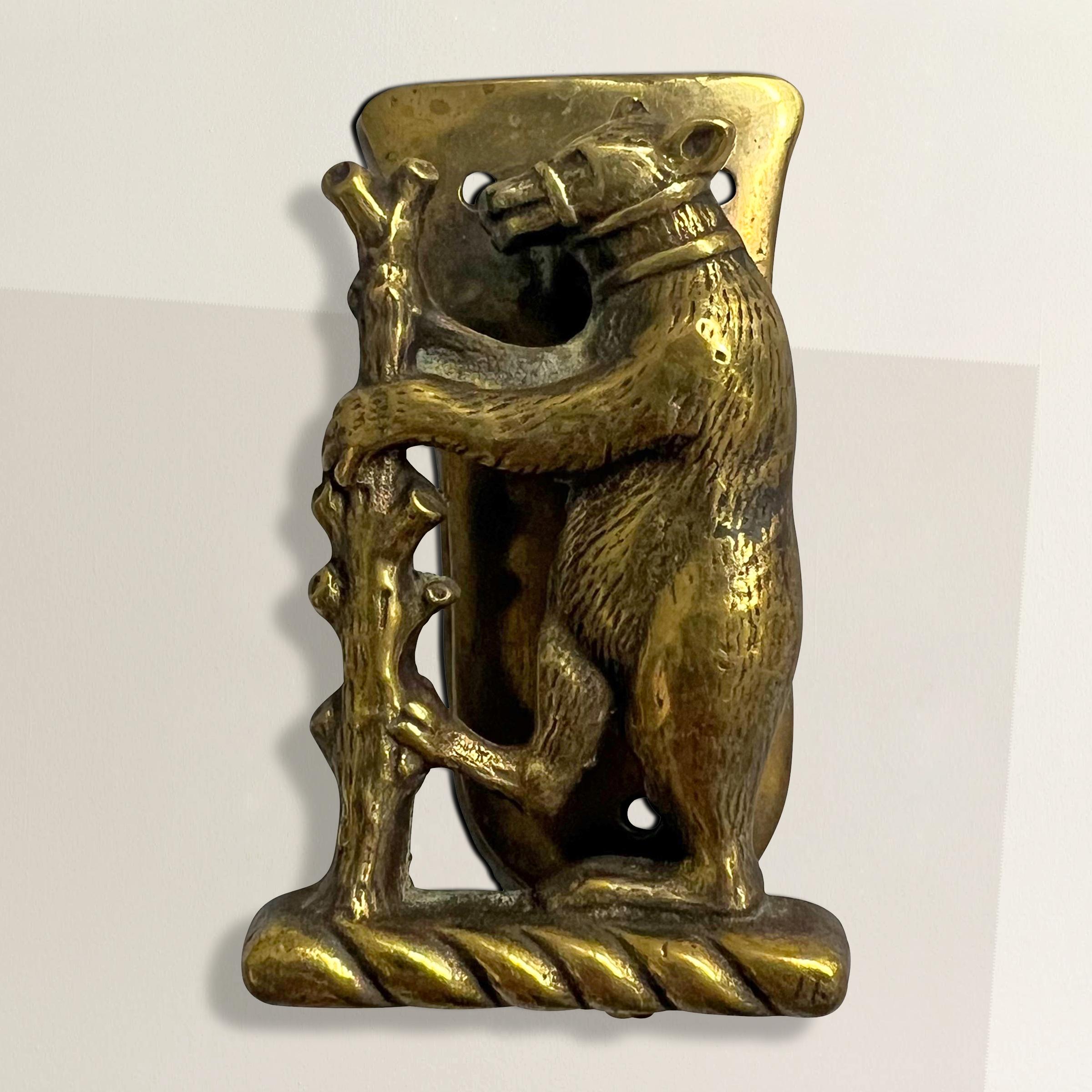 This late 19-century English brass door knocker is a delightful relic of the grand country houses of its era. Small in scale because it was designed for interior doors, it was intended to add a touch of whimsy and charm to guest rooms and bathrooms.