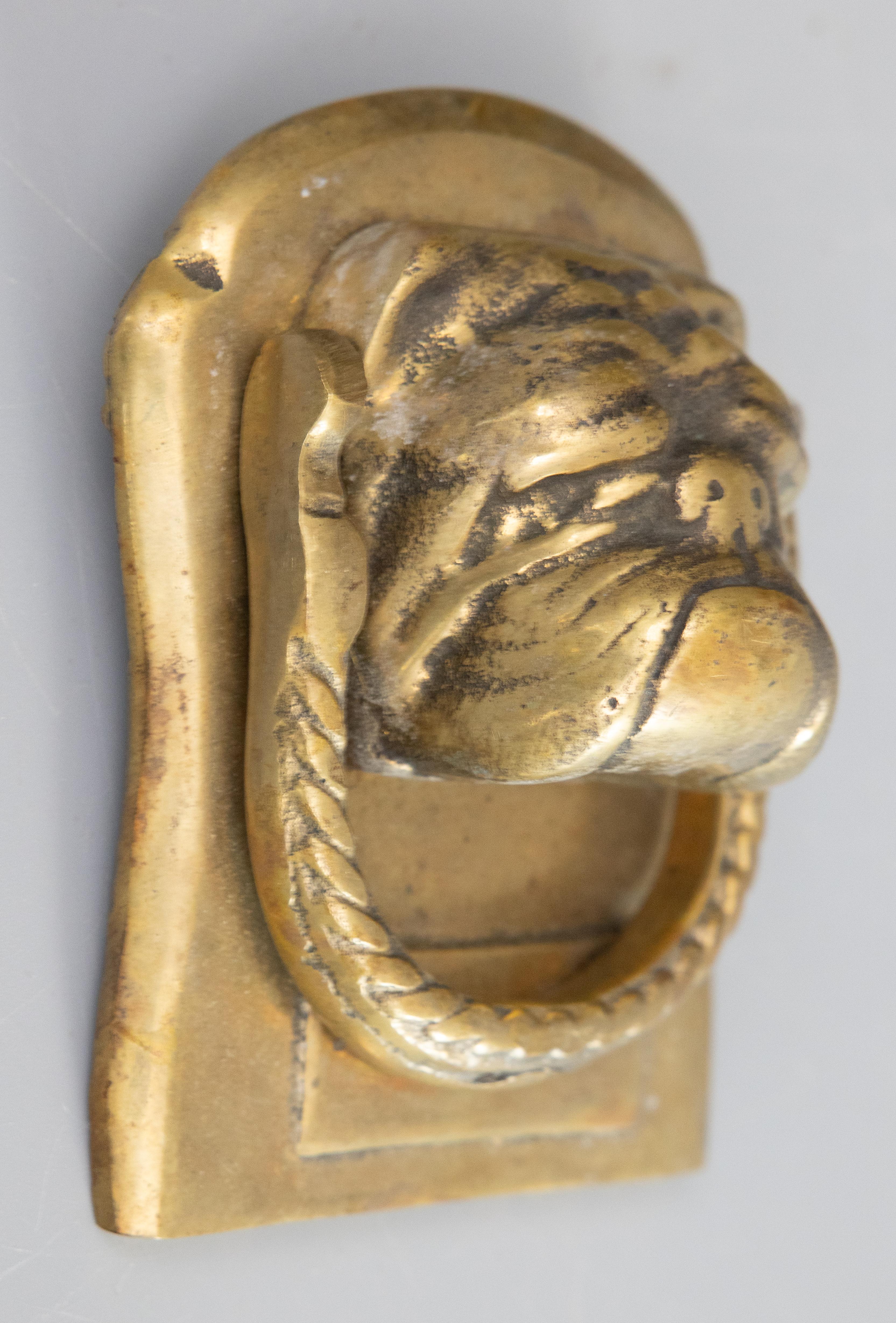 A fine antique 19th Century English brass bulldog door knocker. From a superb collector's estate in England. This charming door knocker is finely cast and heavy, weighing over 2 lbs, with wonderful expression and a lovely brass patina. It would be a