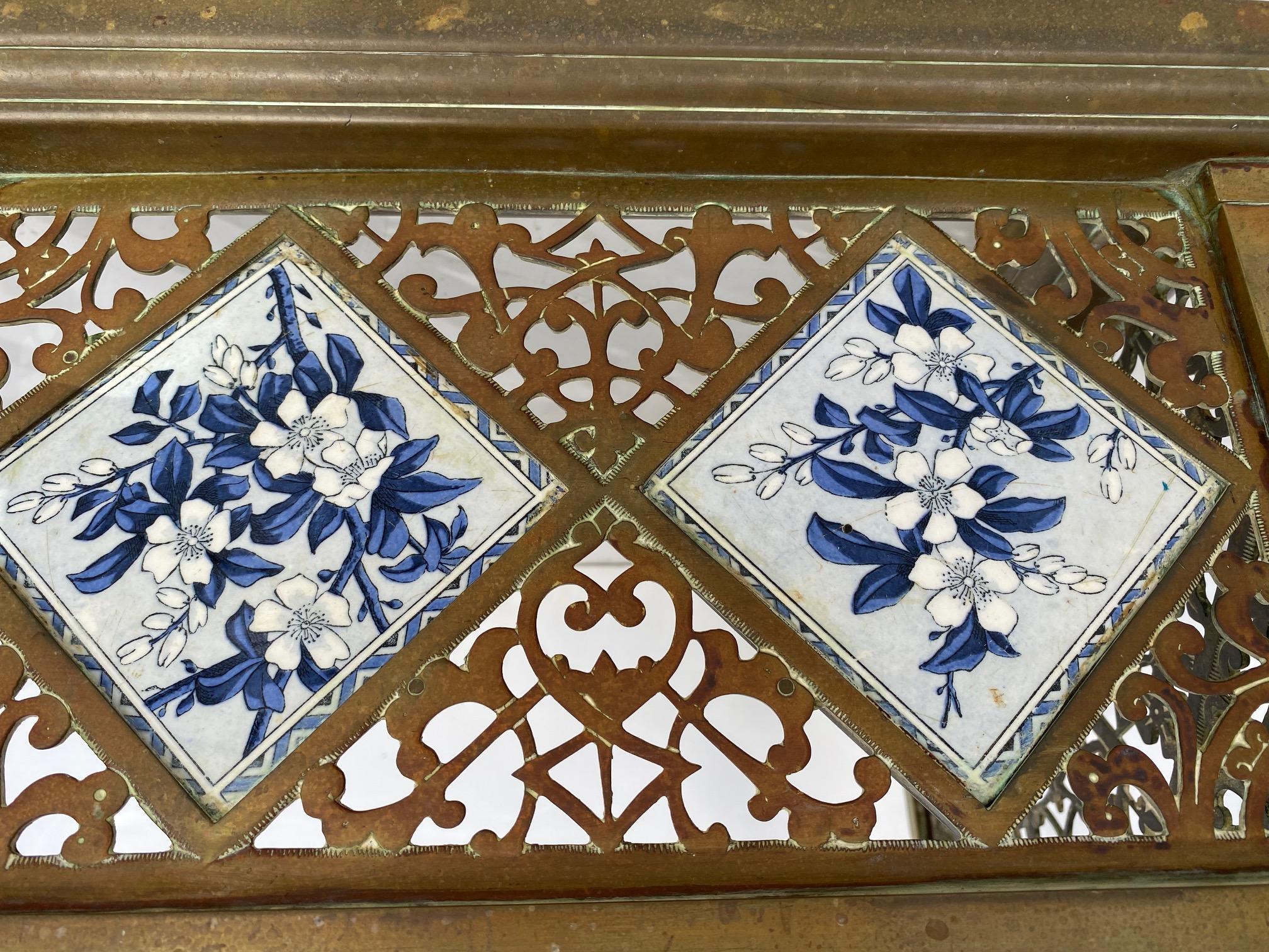 19th-century English fireplace fender fire guard with hand-painted tile accents. 