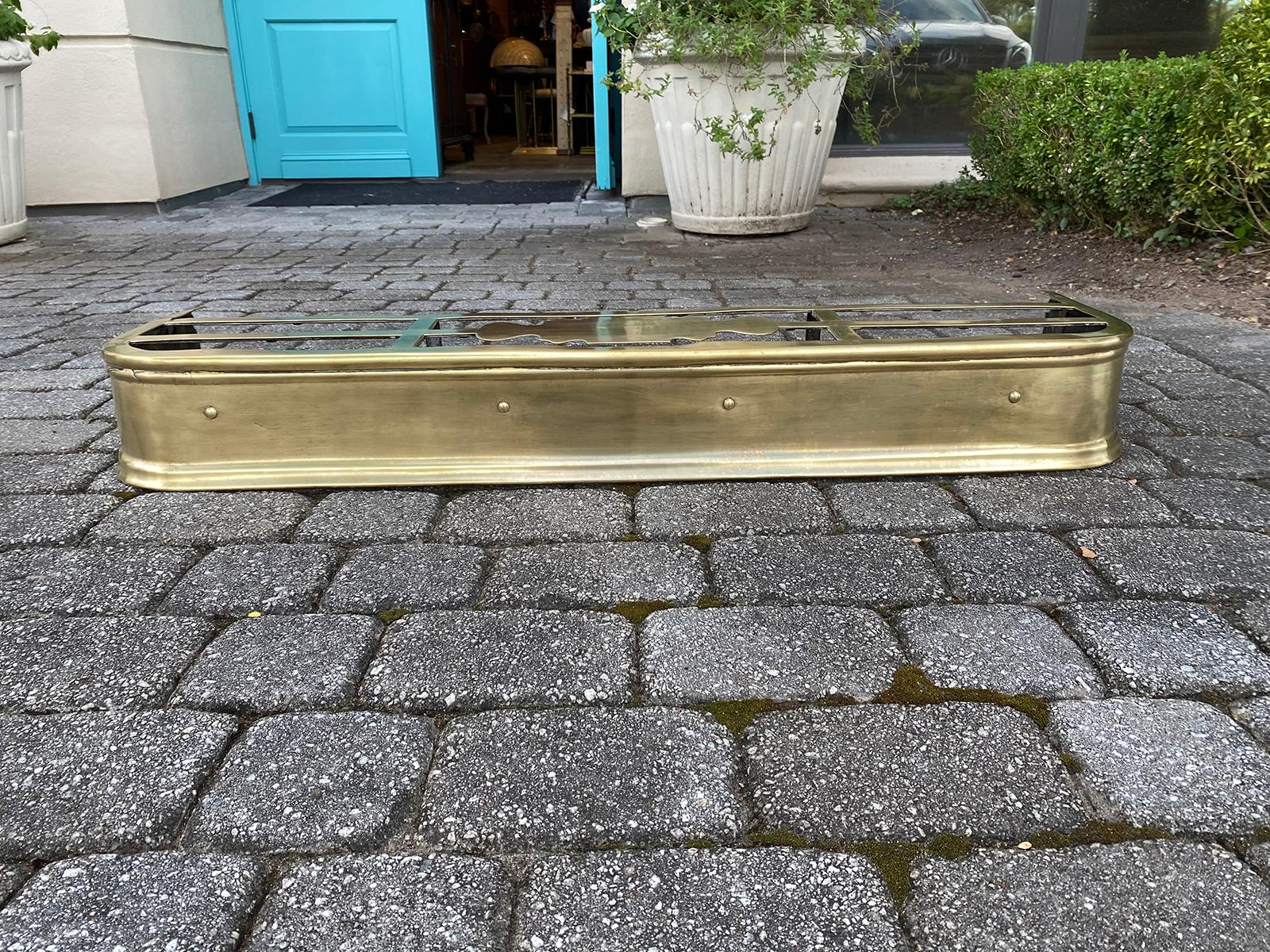 19th century English brass fireplace fender with trivet.