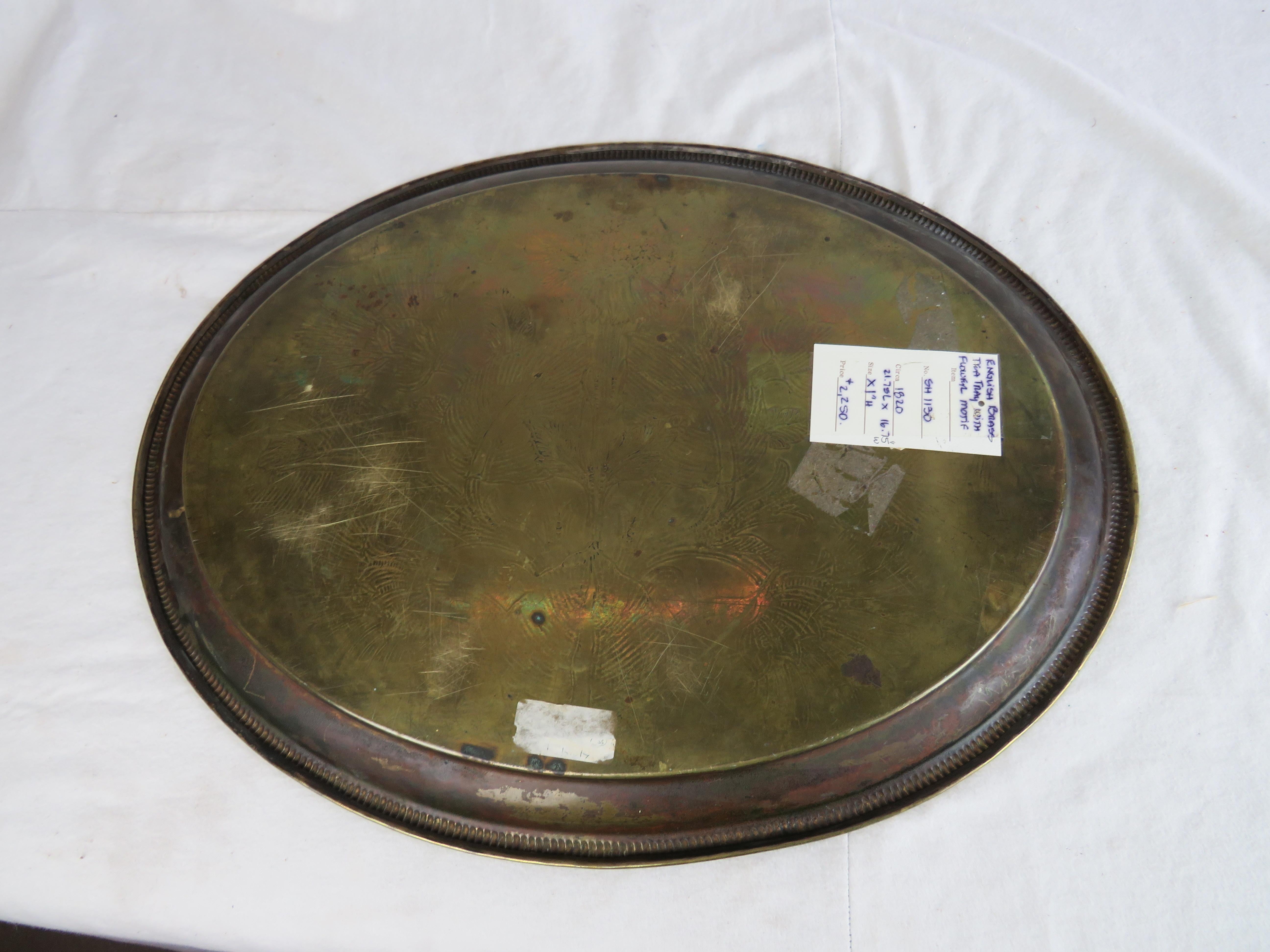 Oval form brass serving/tea tray with reeded edge and central incised floral design, 19th century.