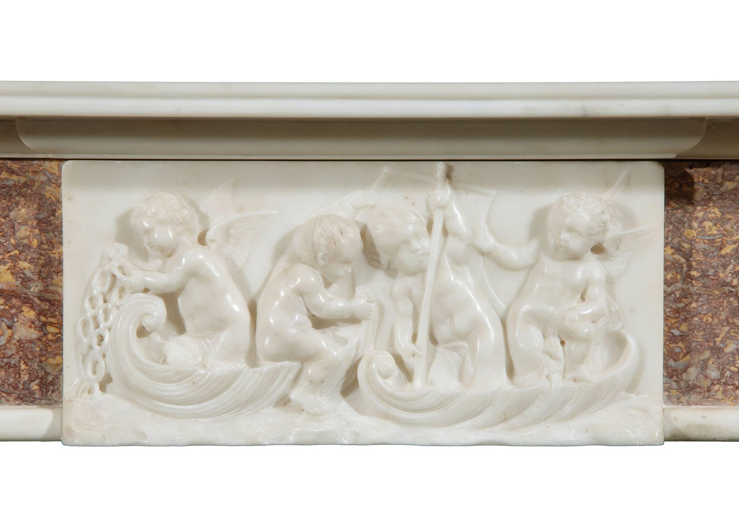 A 19th century English Brocatelle and statuary marble fireplace, with carved centre and side blockings of putti, reeded shelf.

Shelf Width:	1465 mm      	57 5/8 in
Overall Height:	1200 mm      	47 1/4 in
Opening Height:	990 mm      	39 in
Opening