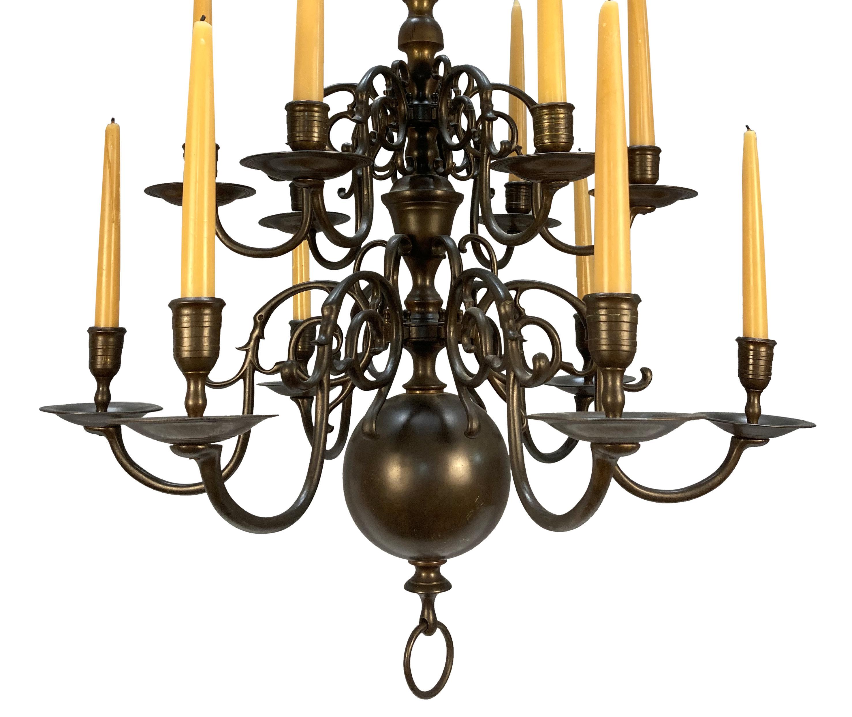 A XIX Century English two tier bronze chandelier in the Dutch taste. With fine scrolled arms, held in place with pins, this chandelier has not been altered for electricity.