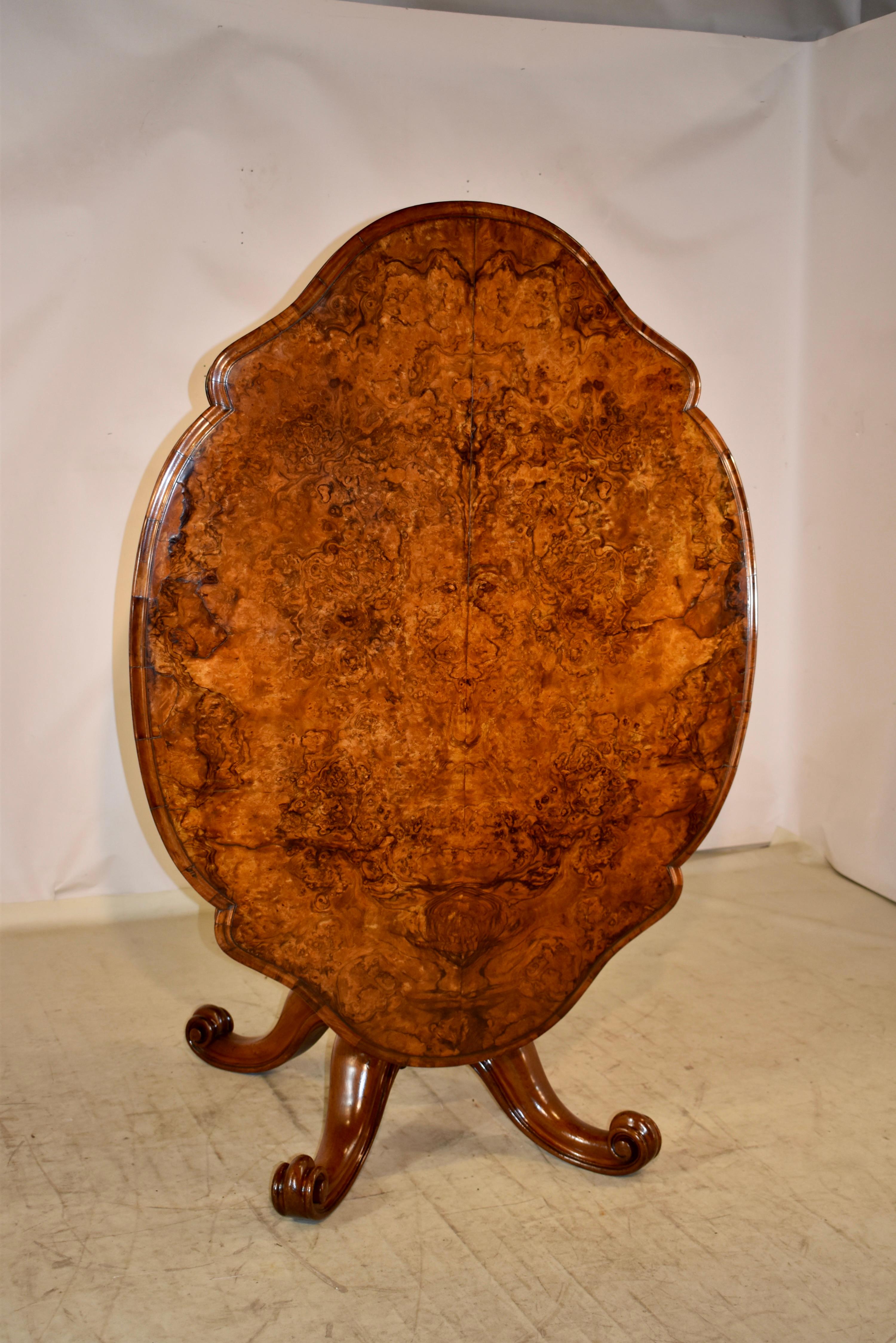 19th century mahogany tilt-top table with a gorgeously grained burl walnut top, which is shaped and beveled around the edge.  The top follows down to a simple apron, which is also made from burl walnut, and has the same rich pattern from the top. 