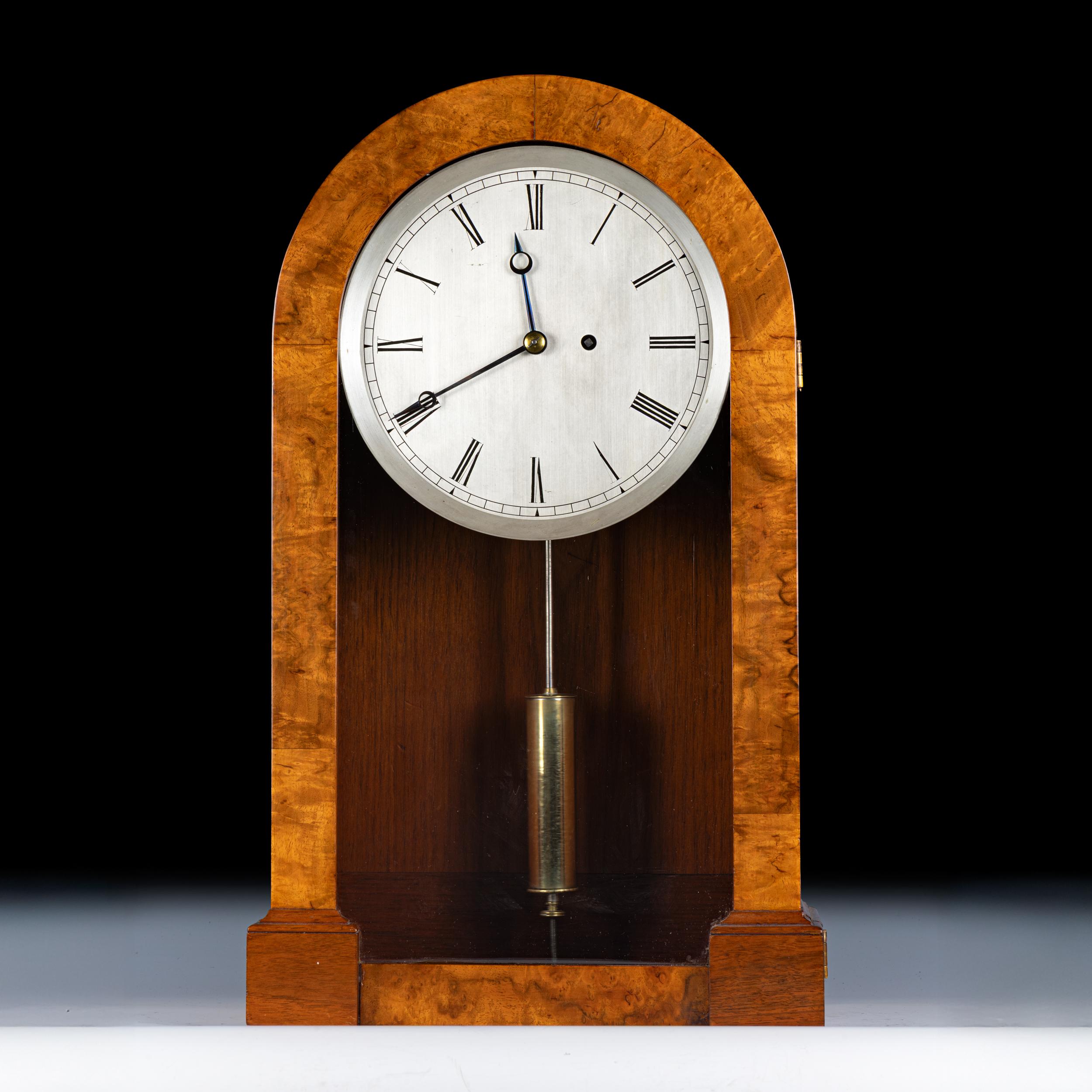 Belle horloge de la fin du 19e siècle en ronce de noyer, avec un plateau arrondi et une base à gradins, et un cadran argenté à chiffres romains.

Circa 1880

Anglais

Très bon état d'origine, légères usures d'usage sur le boîtier et le cadran.

État
