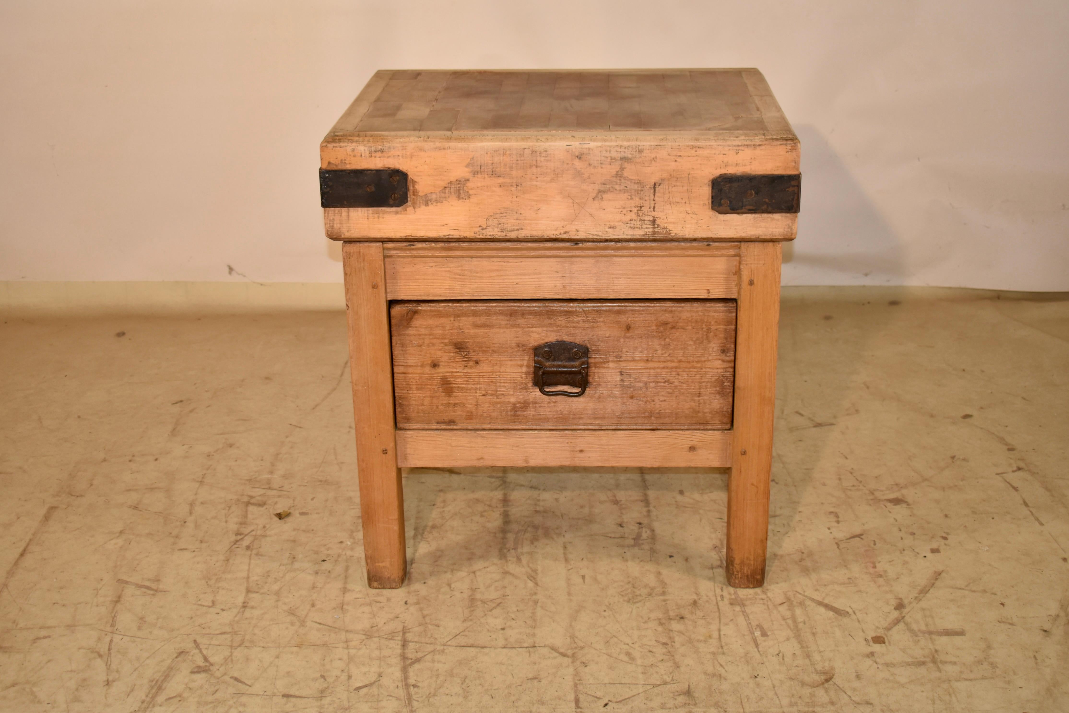 19th century pine and sycamore butcher block from England.

The block is made primarily from sycamore and has lovely color and wear from age and use.  The block has hand made iron straps on the corners, to prevent warpage over the many years of its