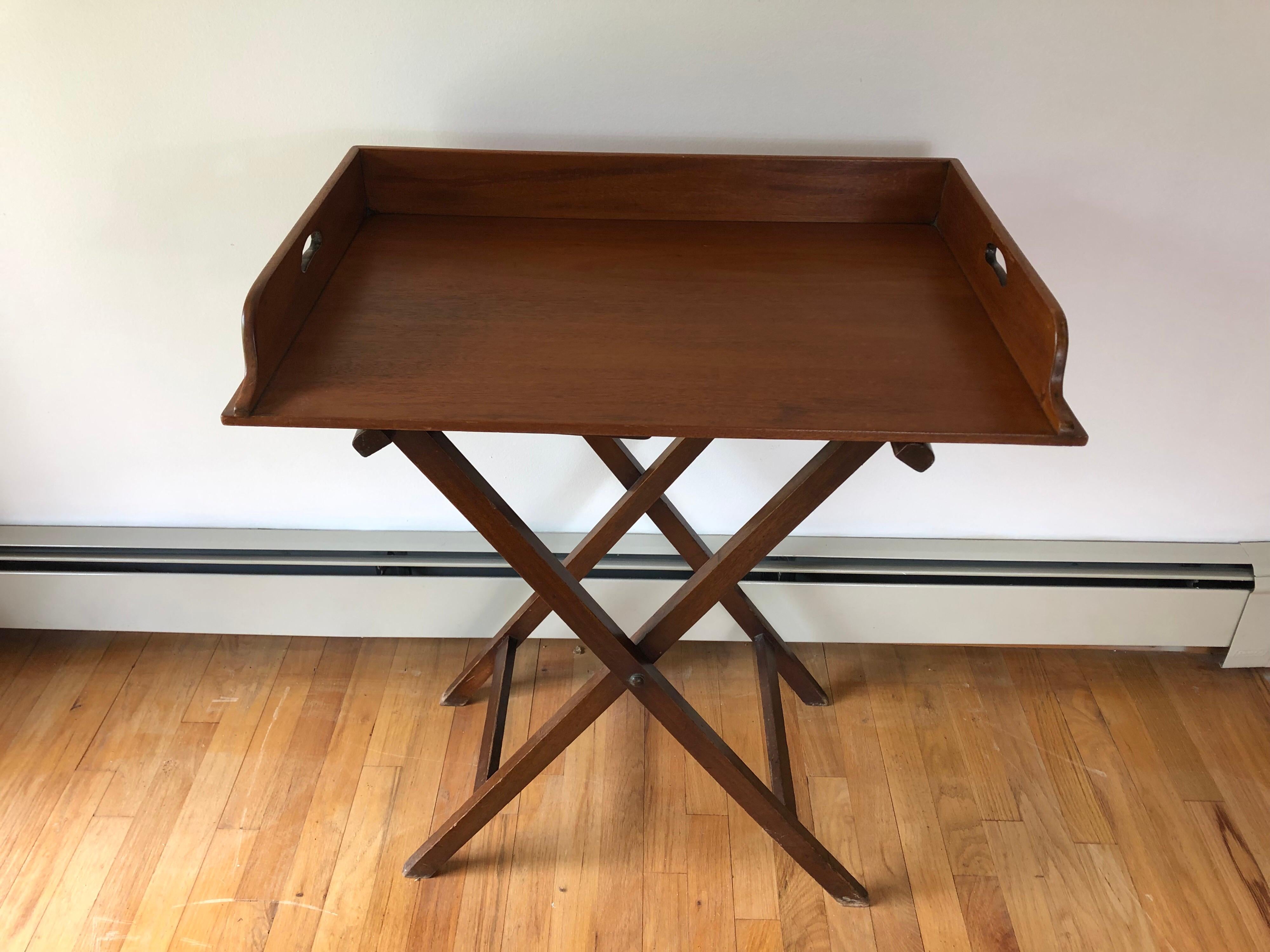 A 19th century English mahogany butler's tray. With removable handled tray top and collapsible base.