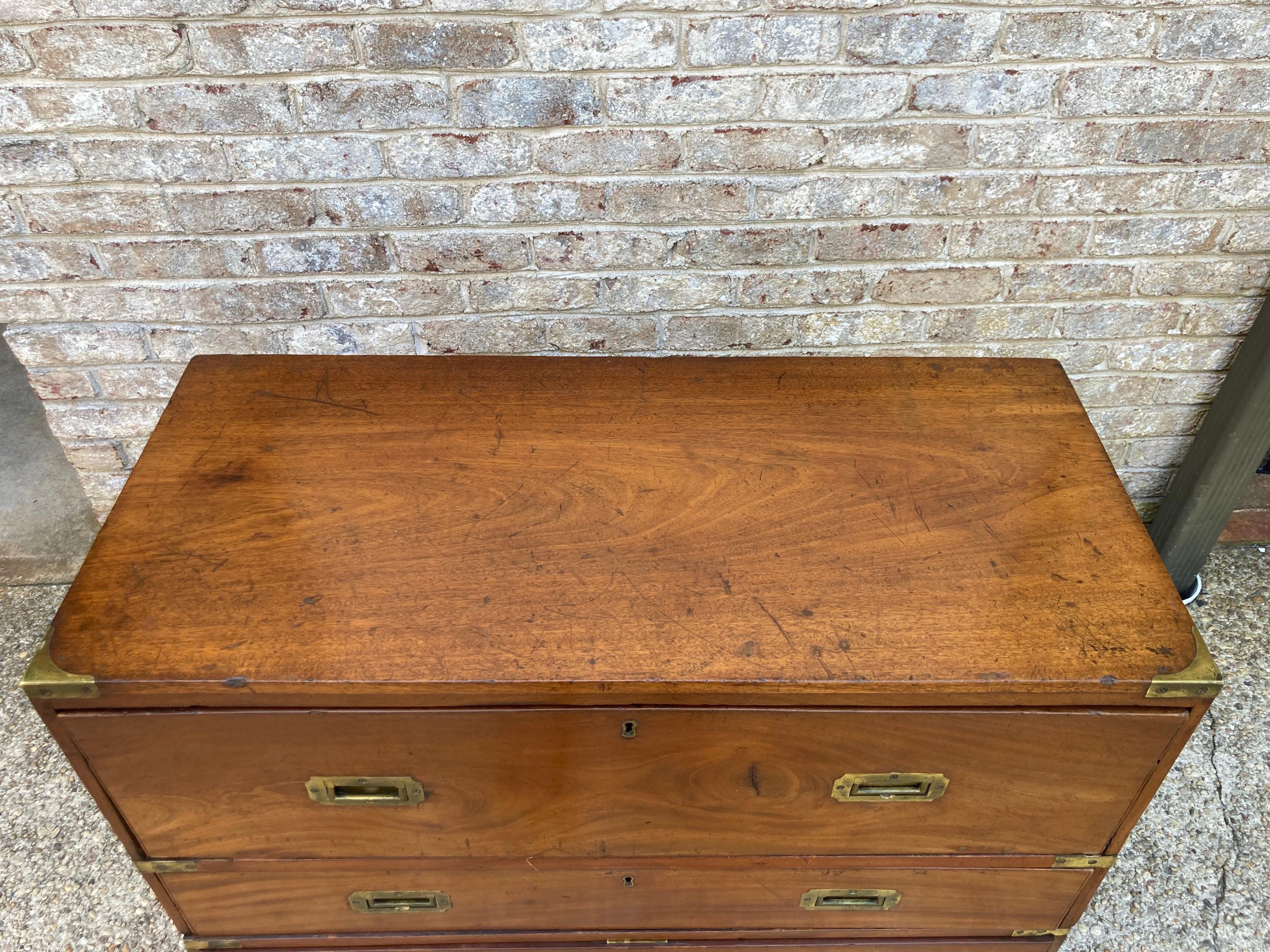 Handsome 19th century two piece campaign chest with a writing desk built into the top drawer....