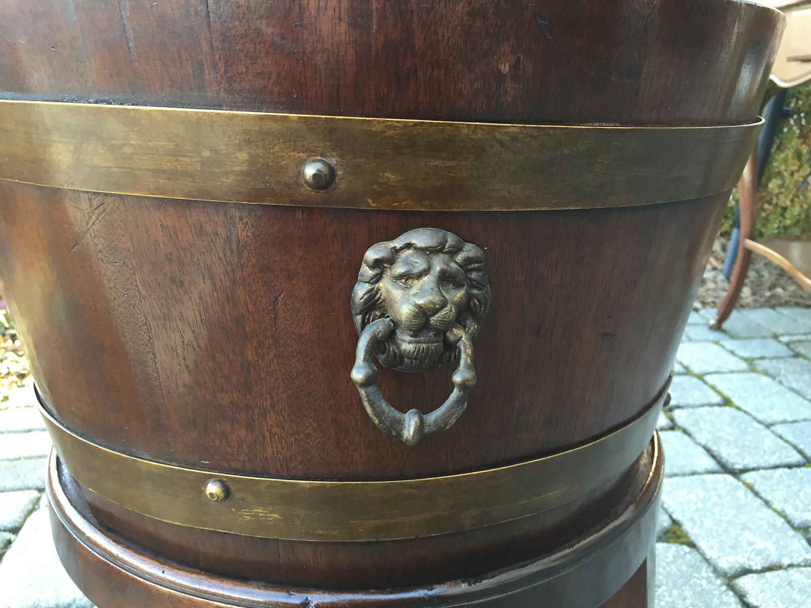 19th century English Campaign style cellarette brass bound bucket on stand with brass lion pulls.
