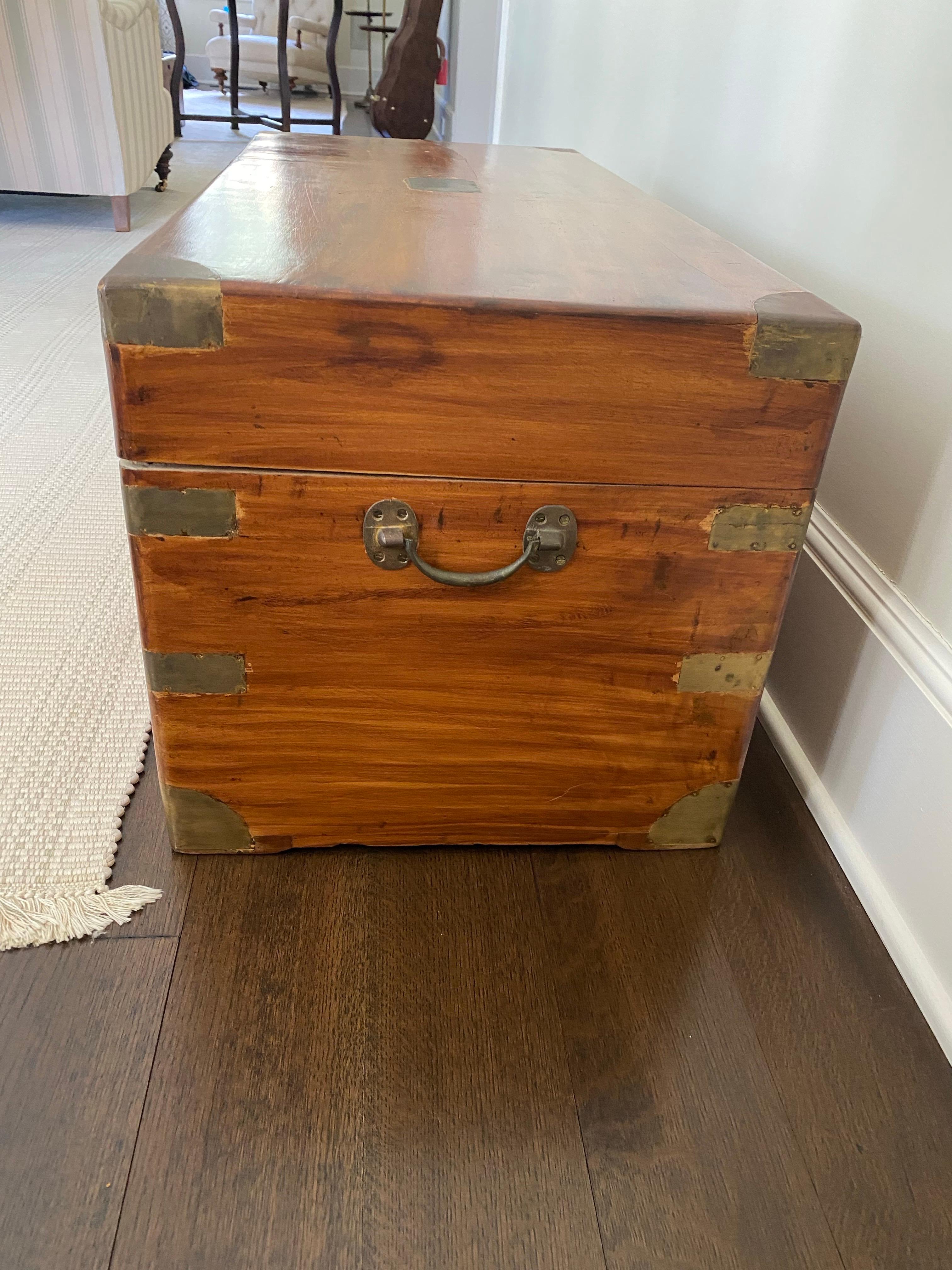 A  Mid-19th Century Camphor Wood Military Campaign Trunk
Crafted from warm-toned wood, lined on the interior with Camphor wood, featuring distinctive brass corner fittings and handles. This chest combines functionality with historical allure,