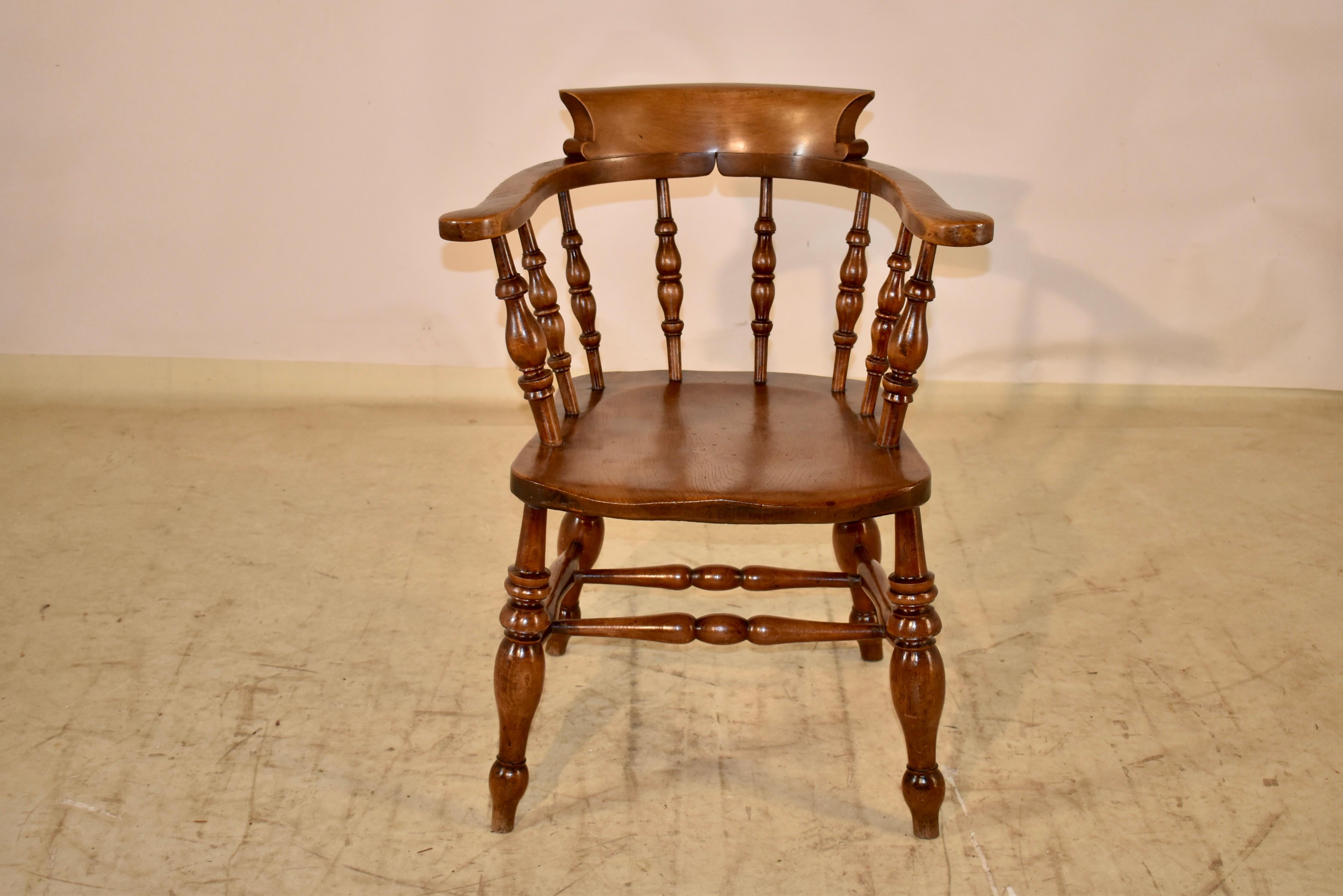 19th century captain's chair from England.  The chair is made from oak and has a seat made from ash.  This type of chair was made for sitting for long periods of time and is very comfortable.  The seat height is 18 inches and the arm height is 29.5