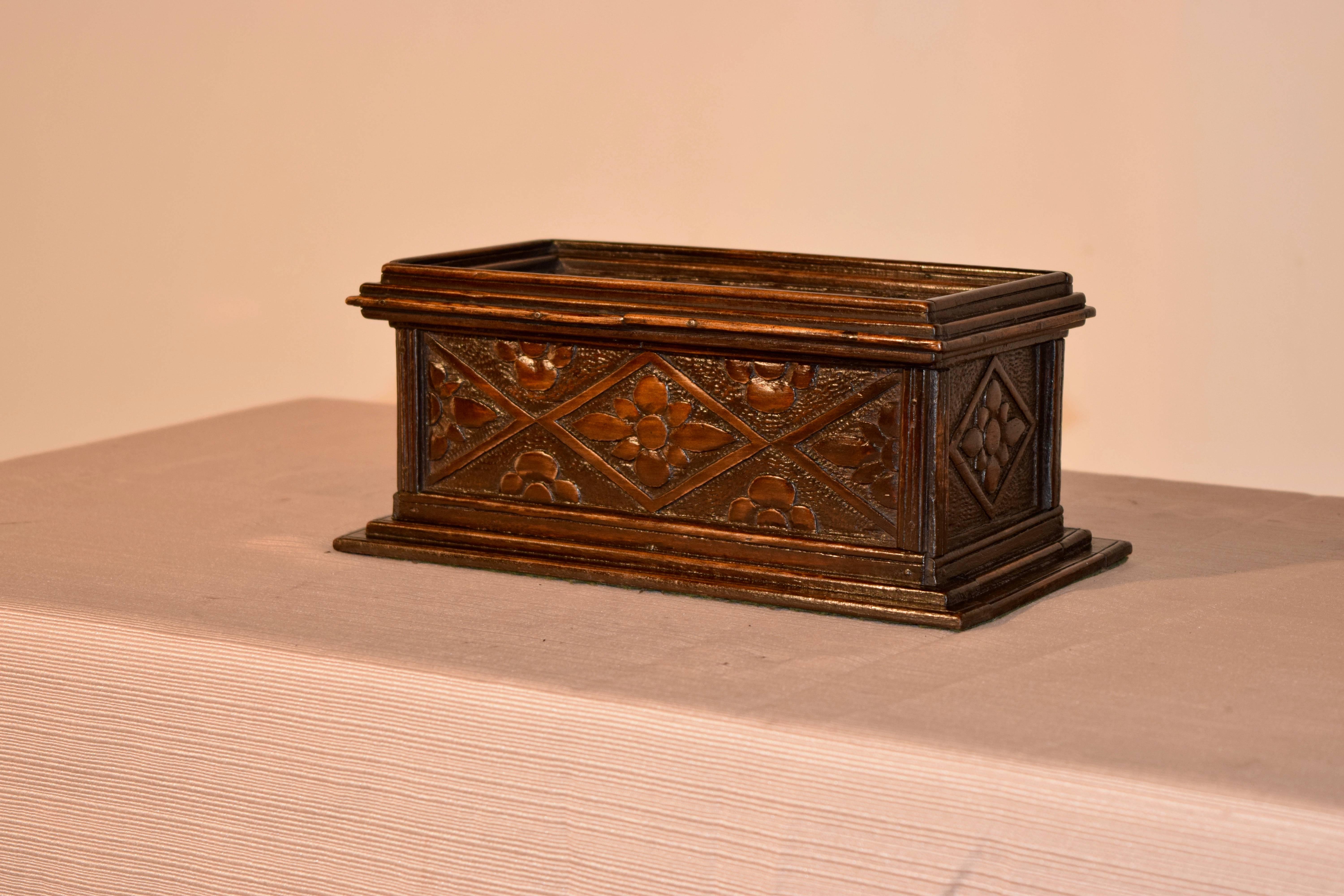 19th century English carved box made from oak. It has molded edges and hand-carved carved decorated sides and top. The top lifts to reveal storage.
 
