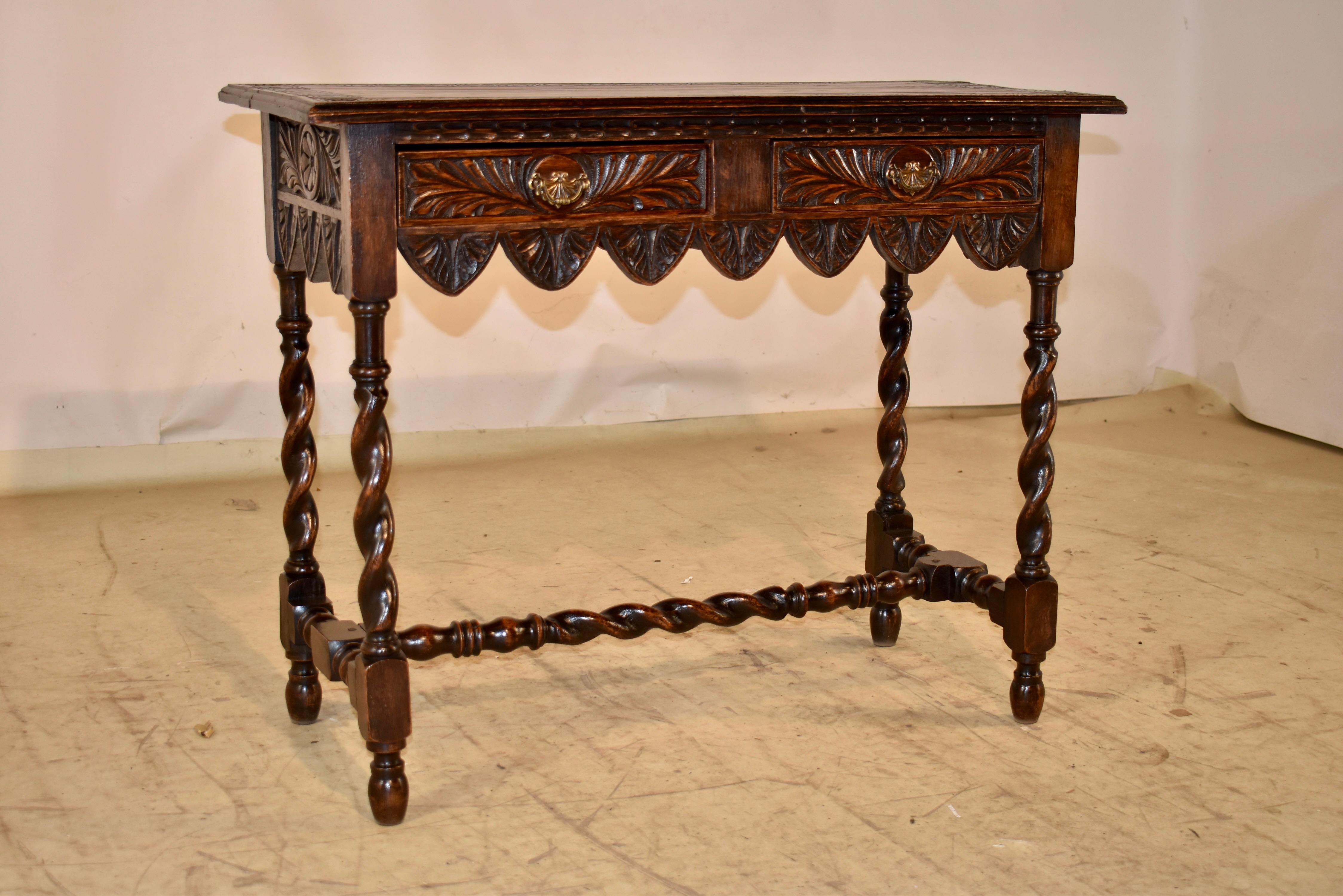 19th century oak console table from England.

The table top has a beveled edge around the top and a central carved band with hand carved decoration. The apron is hand carved decorated on all four sides for easy placement in any room, and terminates