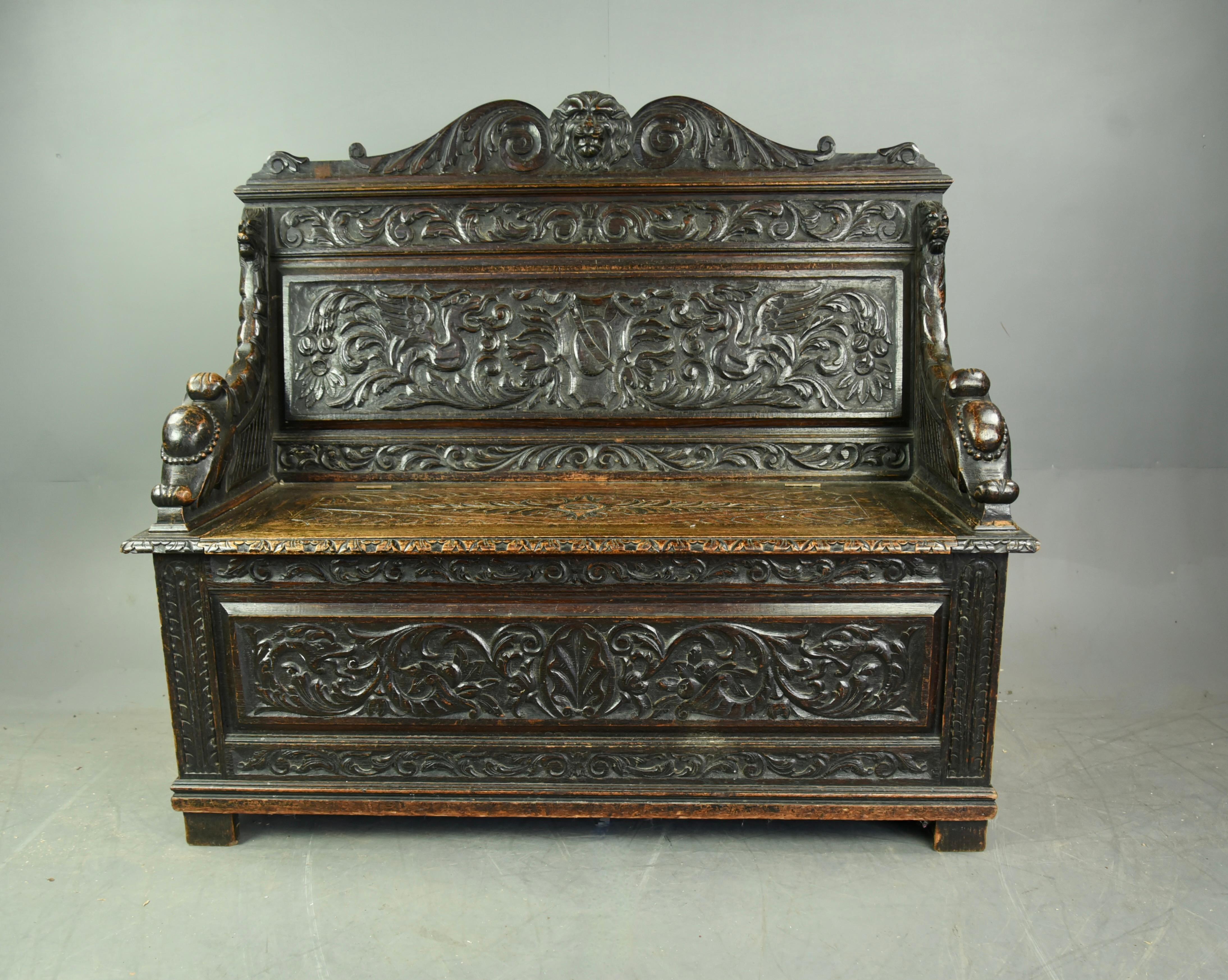 wonderful carved oak settle monks bench. The quality of the carving is excellent with the front, arms and back rest all profusely decorated. The seat is also beautifully carved and lifts to provide storage for boots, shoes, bags etc. This is a very