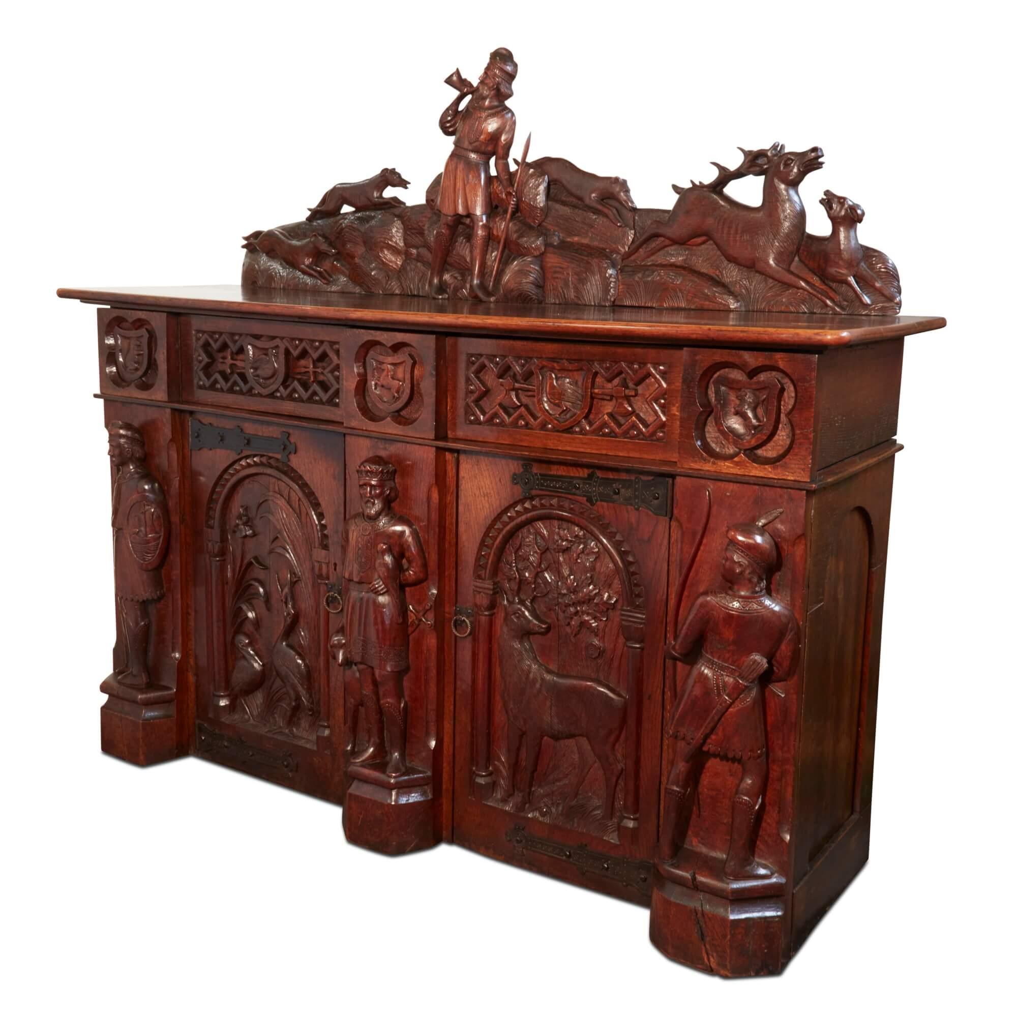 19th century English carved oak cabinet 
English, 19th Century
Height 179cm, width 203cm, depth 62cm

This solid oak cabinet was made in England in the 19th century. It is beautifully carved to depict numerous medieval-style scenes. 

The top of the