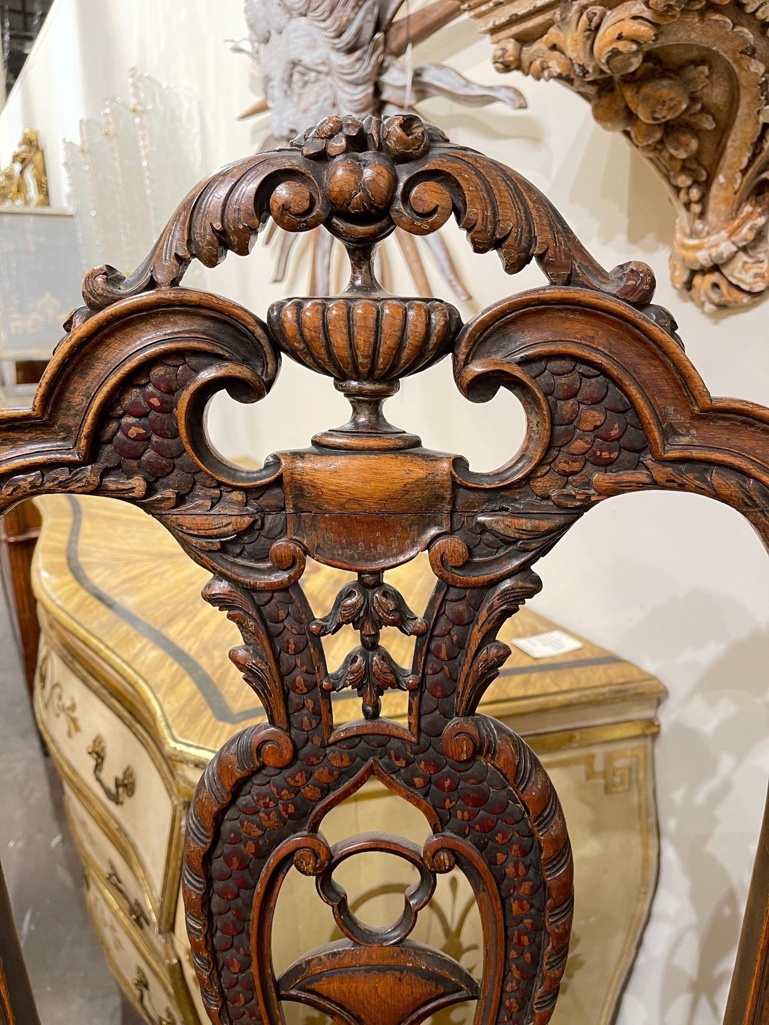Elegant 19th century English carved oak high back chair. Very fine carvings on this piece. An interesting decorative element!