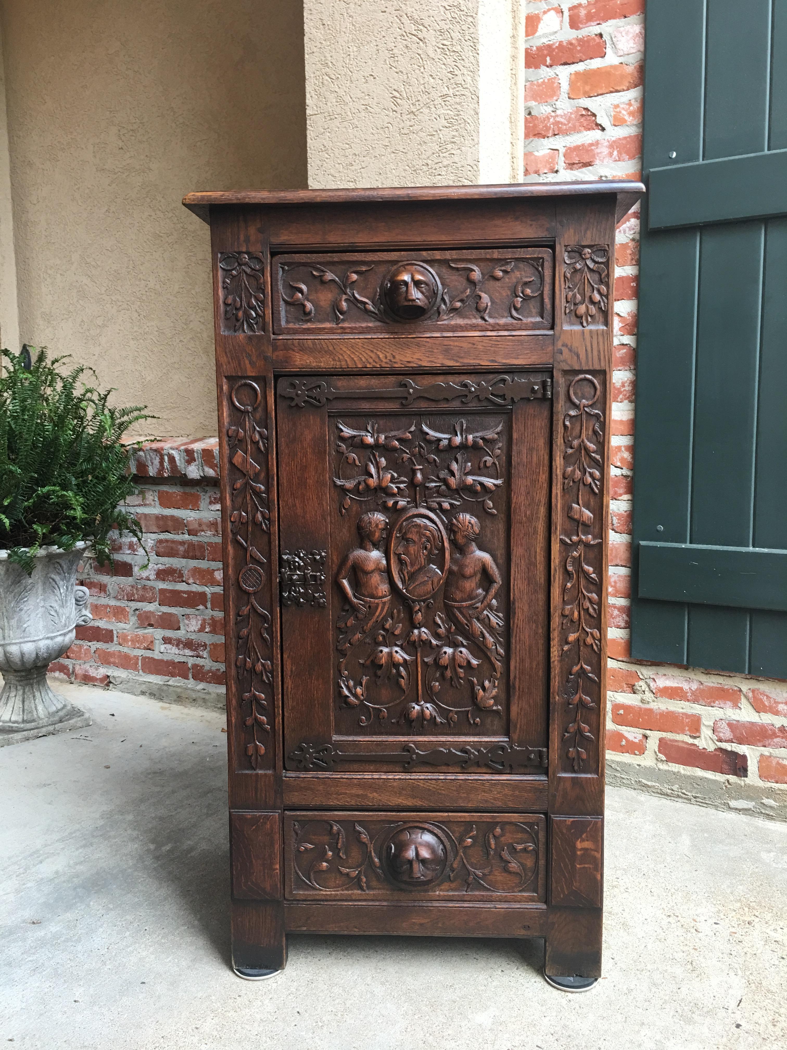Direct from England, ~a gorgeous antique Spanish Renaissance style cabinet with some outstanding hand carved designs!~
~Look at the carved lion(?) mask handles on both the upper drawer and on the lower drawer~
~Fabulous carved panel door has a