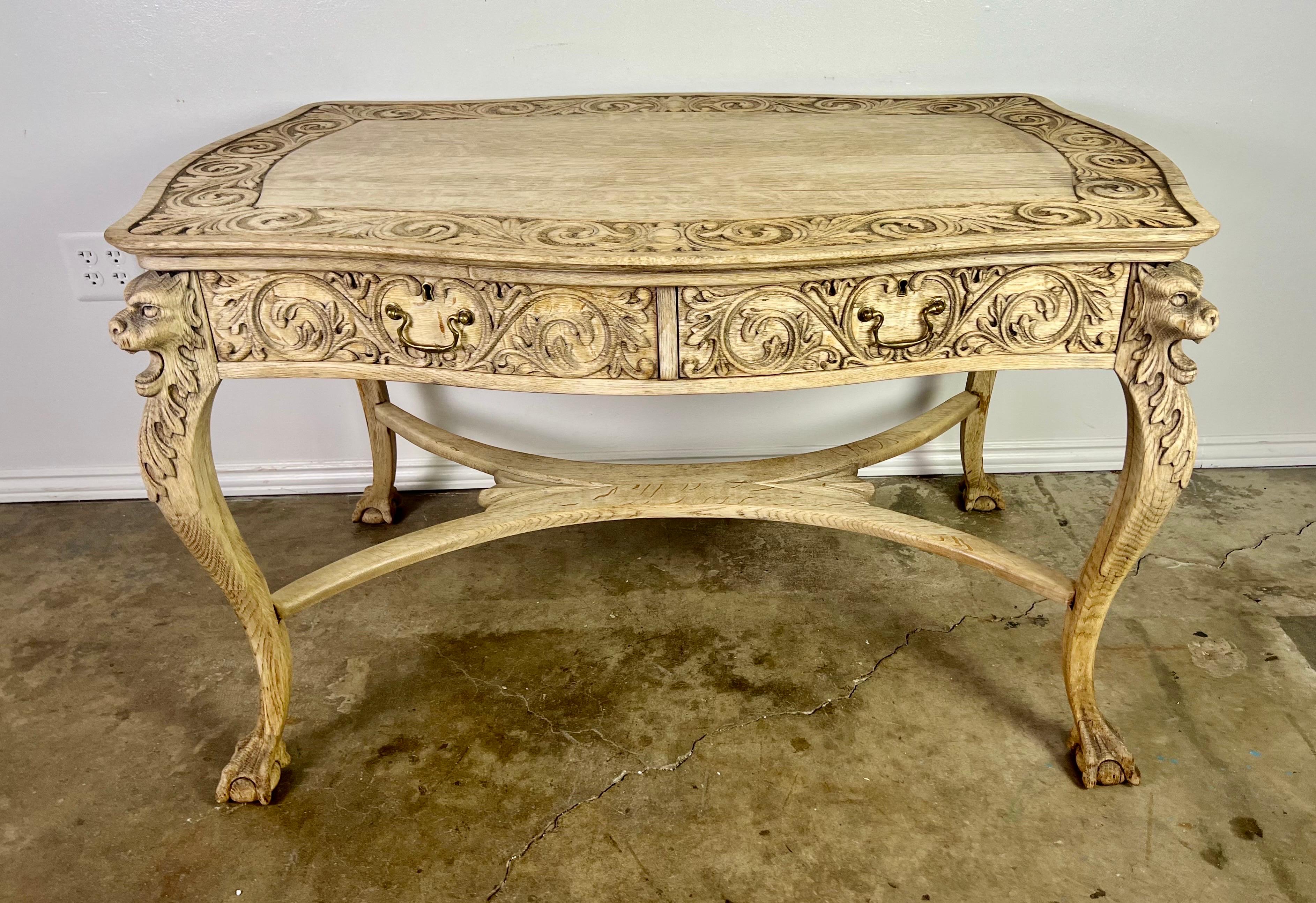 19th century Hand carved English writing partners desk. There are two working drawers on either side so the table can float in your room. It stands on four ball & claw feet. The table is finely carved with details of lion heads, acanthus leaves,