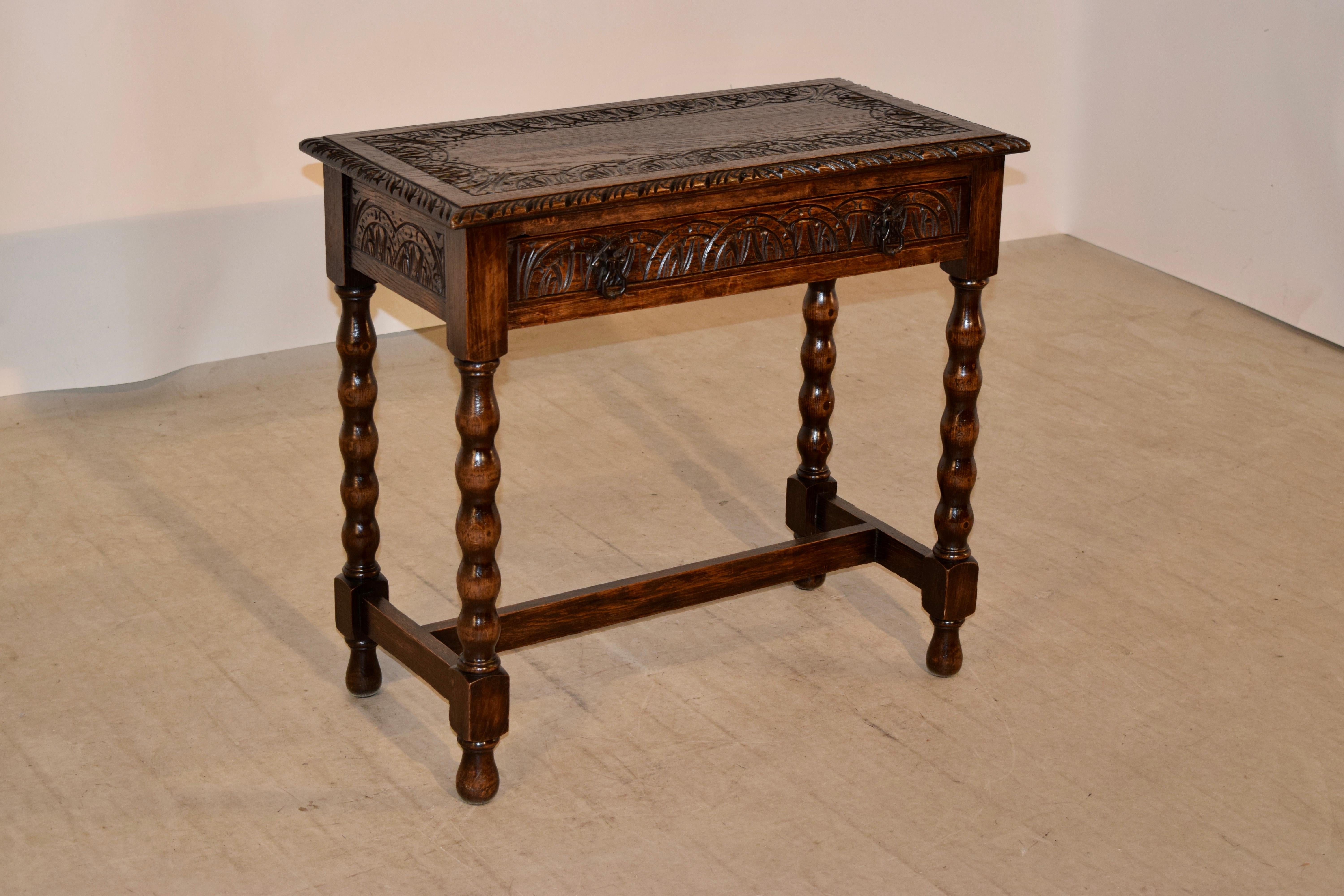 19th century English oak side table with a hand carved decorated border around the top with a bevelled and hand carved edge as well. This follows down to a hand carved apron on all four sides for easy placement in any room and contains a single