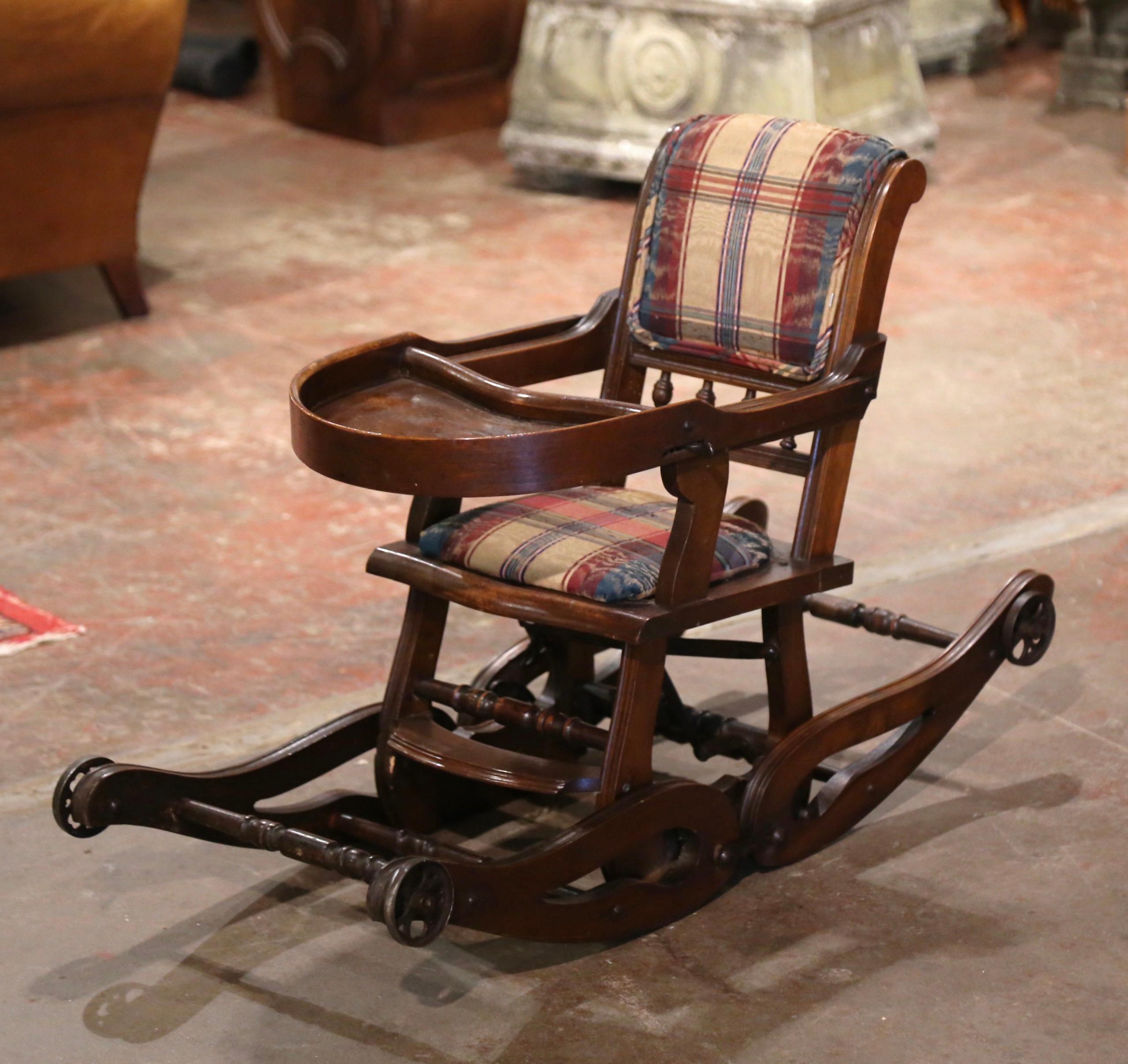 Feed your child in style or let him/her play in the antique and ingenious Victorian high chair! Crafted in England circa 1880 and made of walnut wood and upholstered with plaid fabric, the charming baby chair has a double function; to feed a child