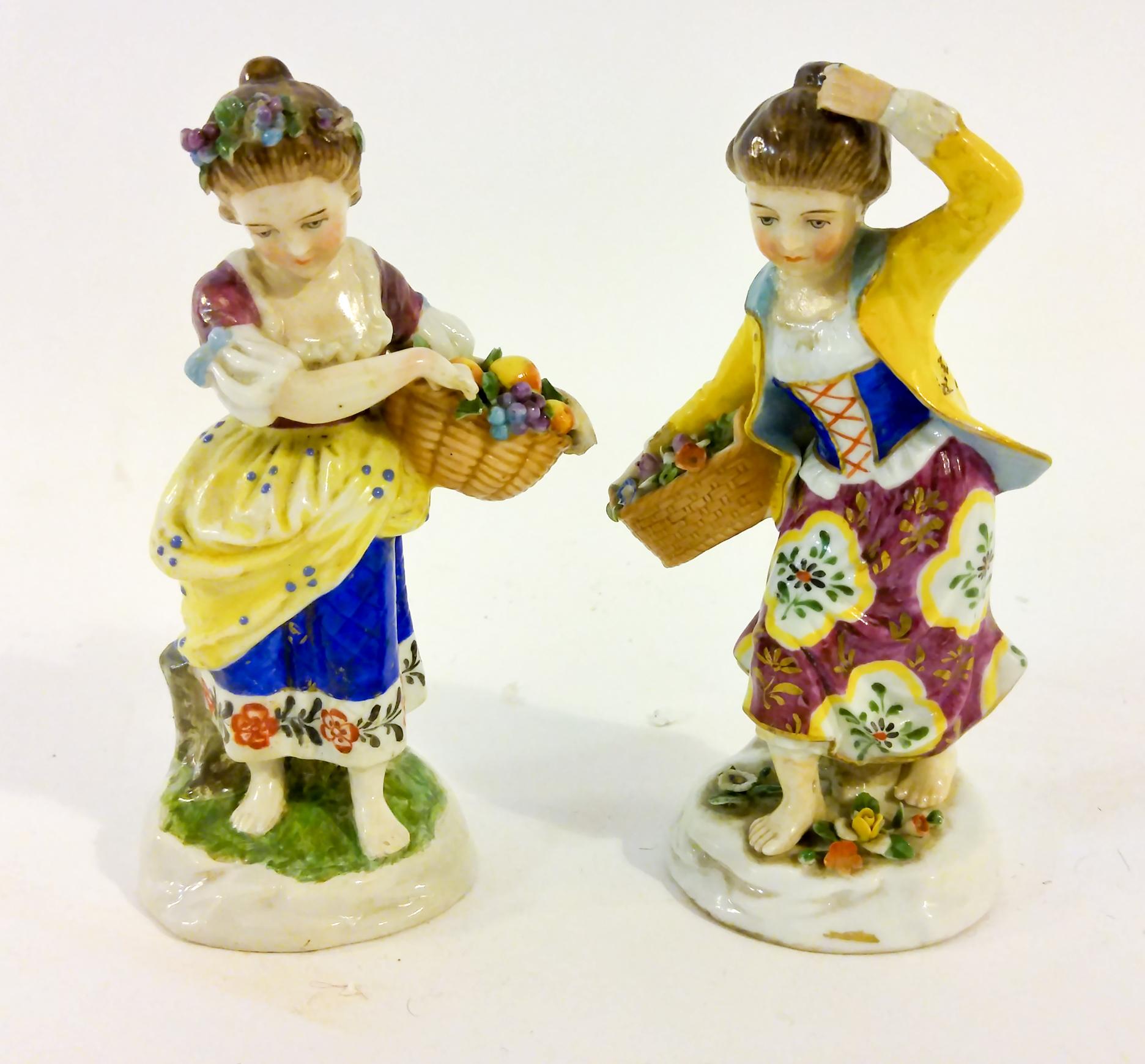 Charming pair of very intricate figurines of barefoot young girls, one gathering a basket of fruit and the other flowers. Only one is marked (with the gold anchor.) The colors are very brilliant and the details are incredible. 