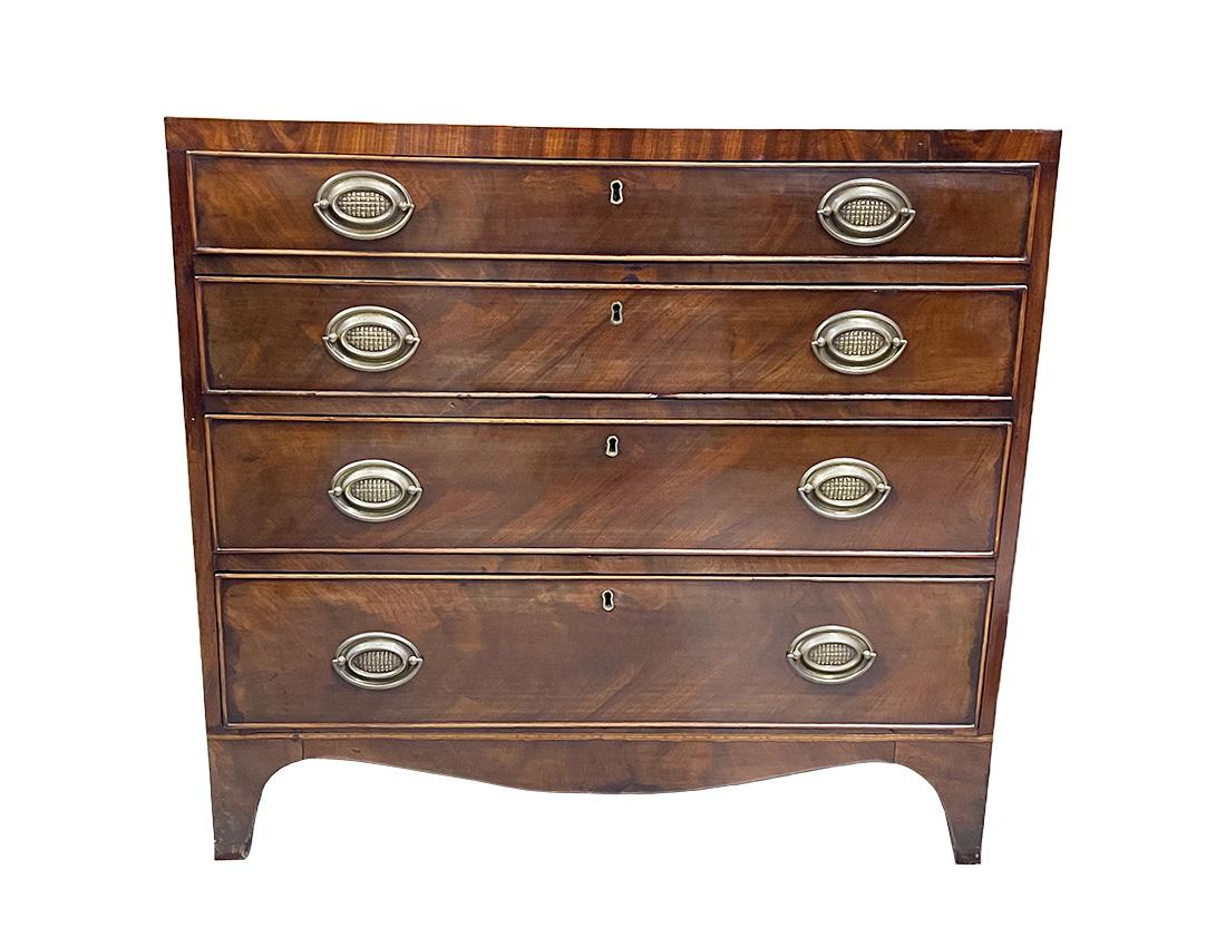 19th Century English chest of drawers

An 19th century English mahogany chest of drawers with 4 fitted drawers. The fittings have an oval shape with a basket weave pattern and semi-oval movable handles. This beautiful piece of furniture has some