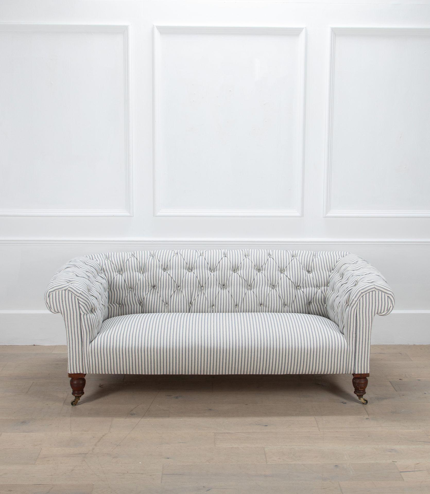 A handsome late 19th Century English deep-buttoned chesterfield sofa. Reupholstered from the frame, this has been finished in a linen ticking with a fixed seat.
A timeless classic.