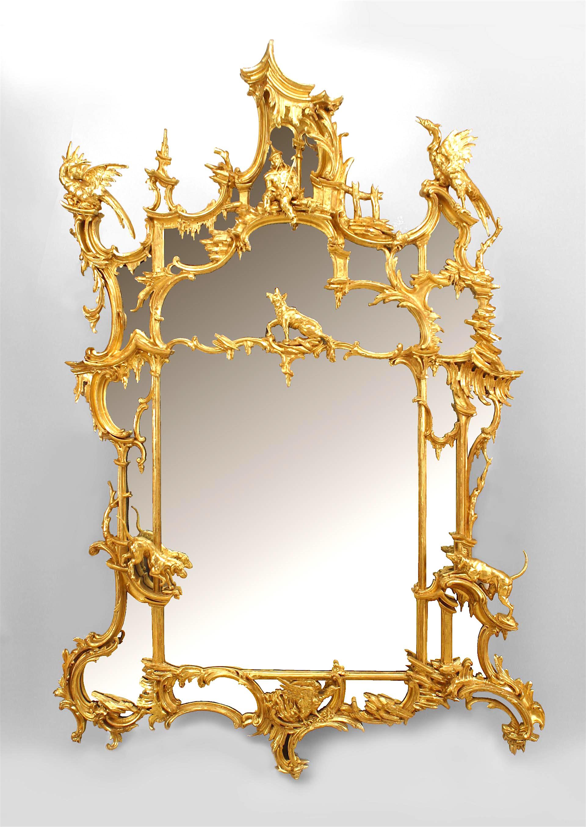 English Chinese Chippendale-style (late 19th Century) carved giltwood wall mirror with pagoda top above a seated figure, birds, hounds, and a fox. (in the manner of THOMAS JOHNSON circa 1758)