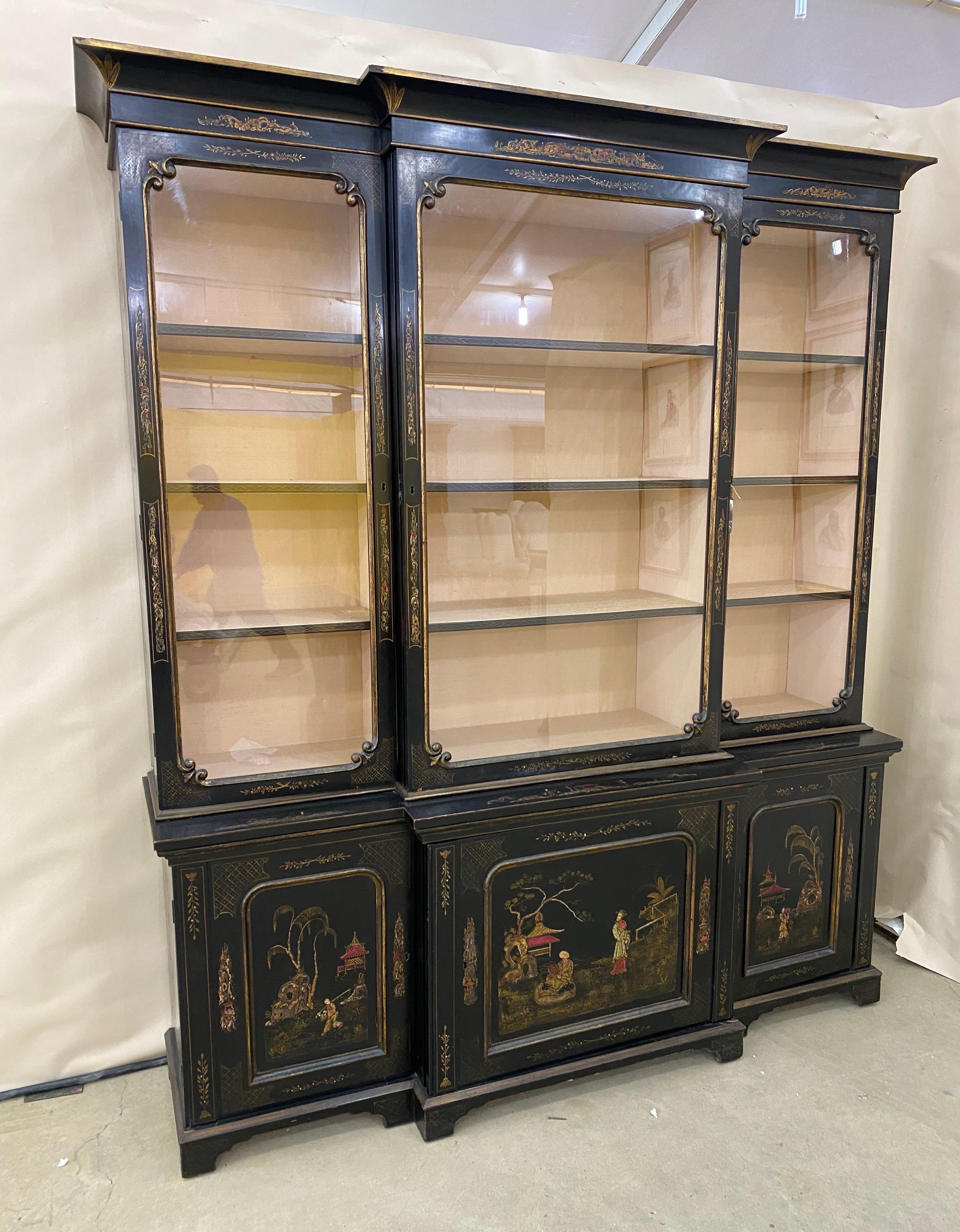 Great 19th century English chinoiserie breakfront china cabinet or bookcase- 2 part cabinet with single center door for more unobstructed view. Chinoiserie decoration on both top and bottom cabinets, sides included.