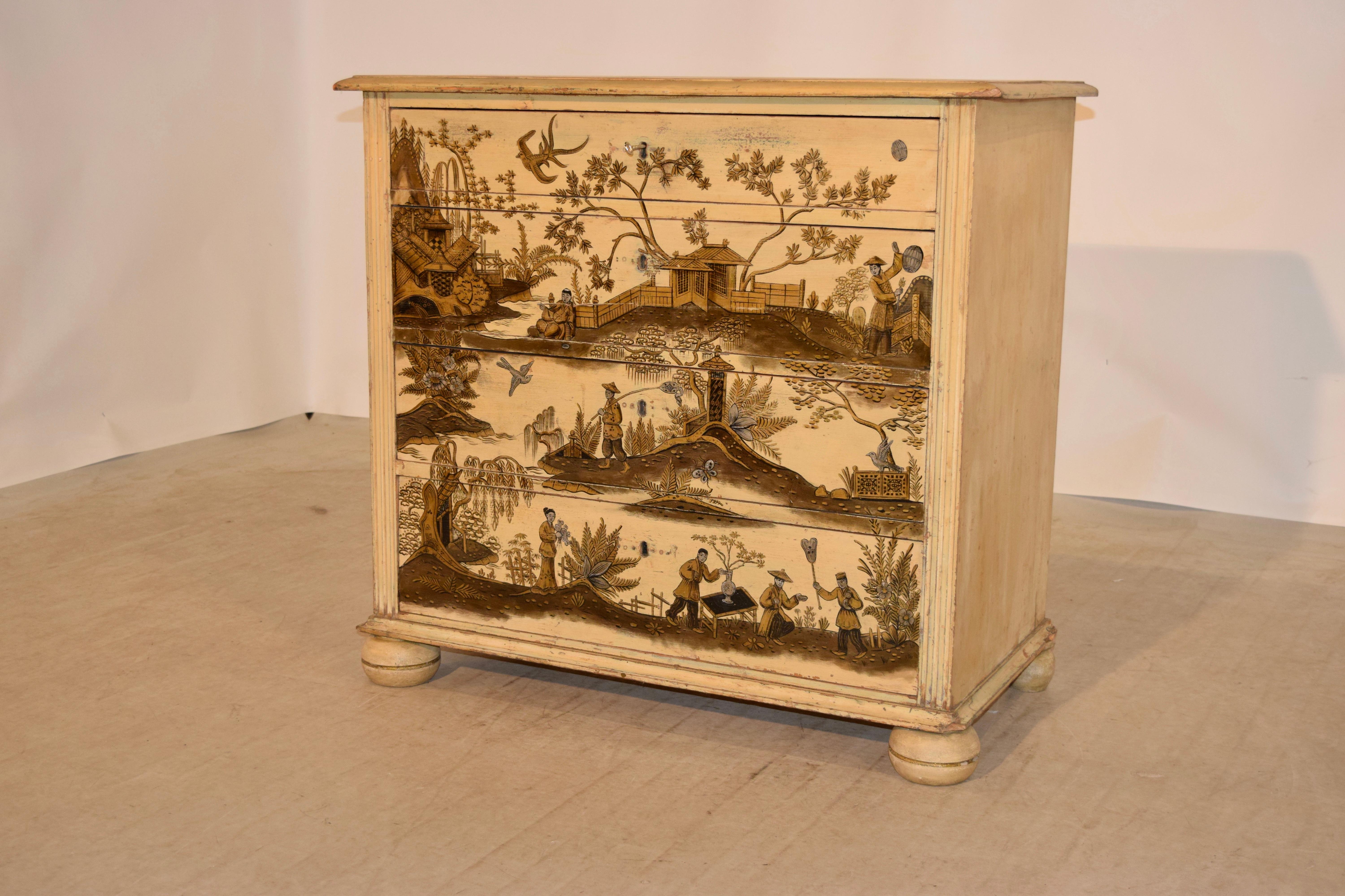 19th century English chest of drawers with a beveled edge around the top following down to reeded columns flanking four central drawers, supported on hand turned bun feet. The painting was added at a later date. The chest has a single key.