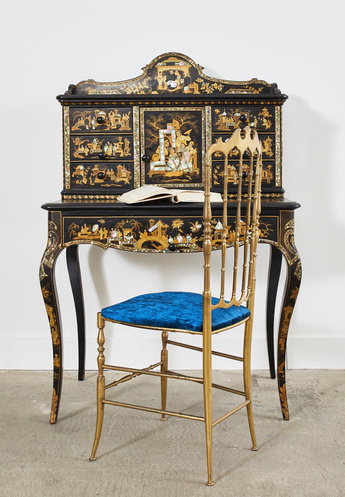 Extraordinary 19th century English ladies secretaire desk or writing table. The two part desk was made in the Chinoiserie revival period of Europe in the mid-19th century. The desk features a Japanned oak case embellished with highly detailed inlay