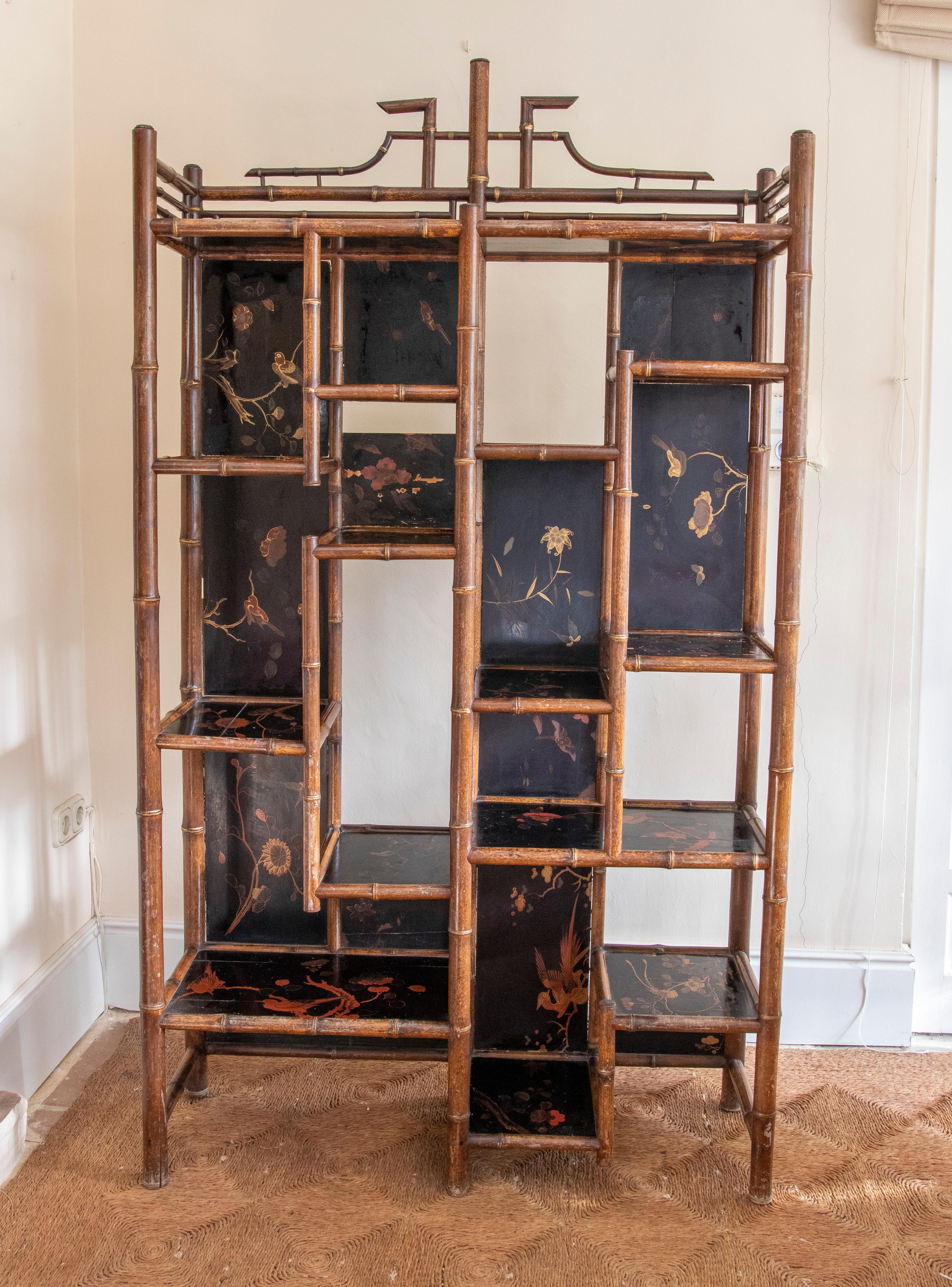 19th century English Chinoiserie style bamboo bookcase with Lacquered decoration.