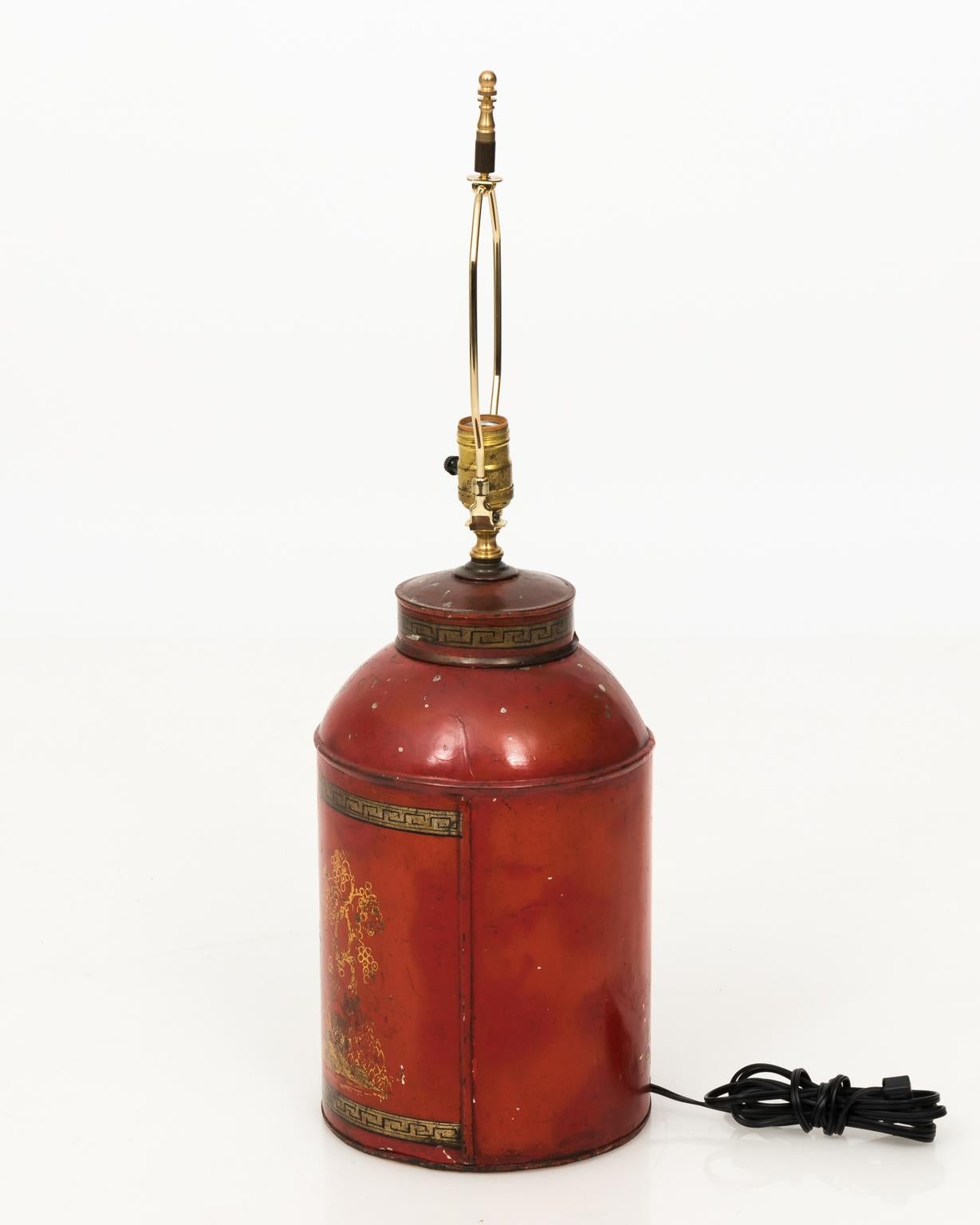 English Chinoiserie style red painted tea canister lamps with gold painted figures. Shade not included, circa 19th century.