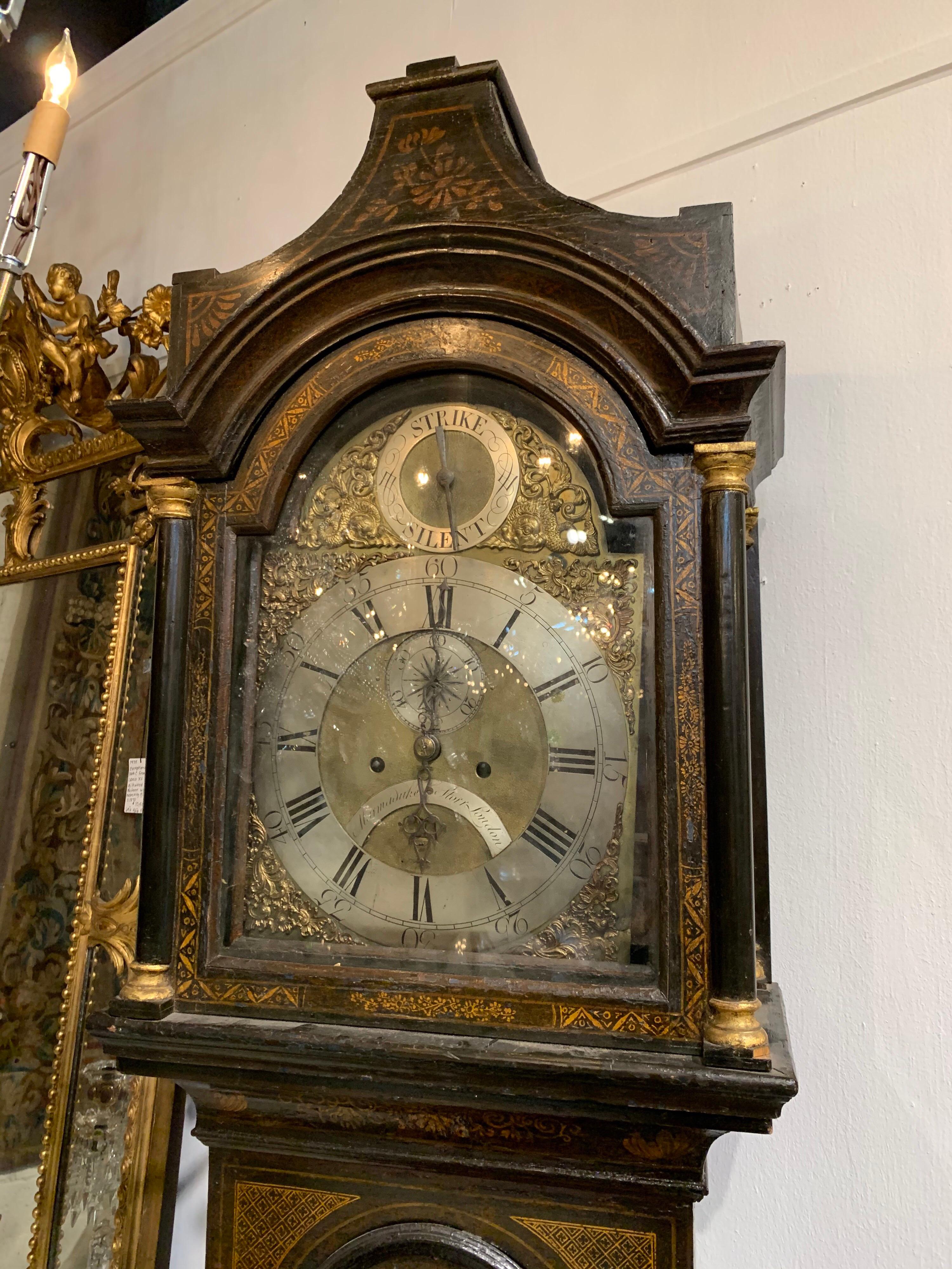 Beautiful 19th century English chinoiserie tall case clock. Lovely painted images on the piece and the face of the clock has a very pretty scrolling brass design.
