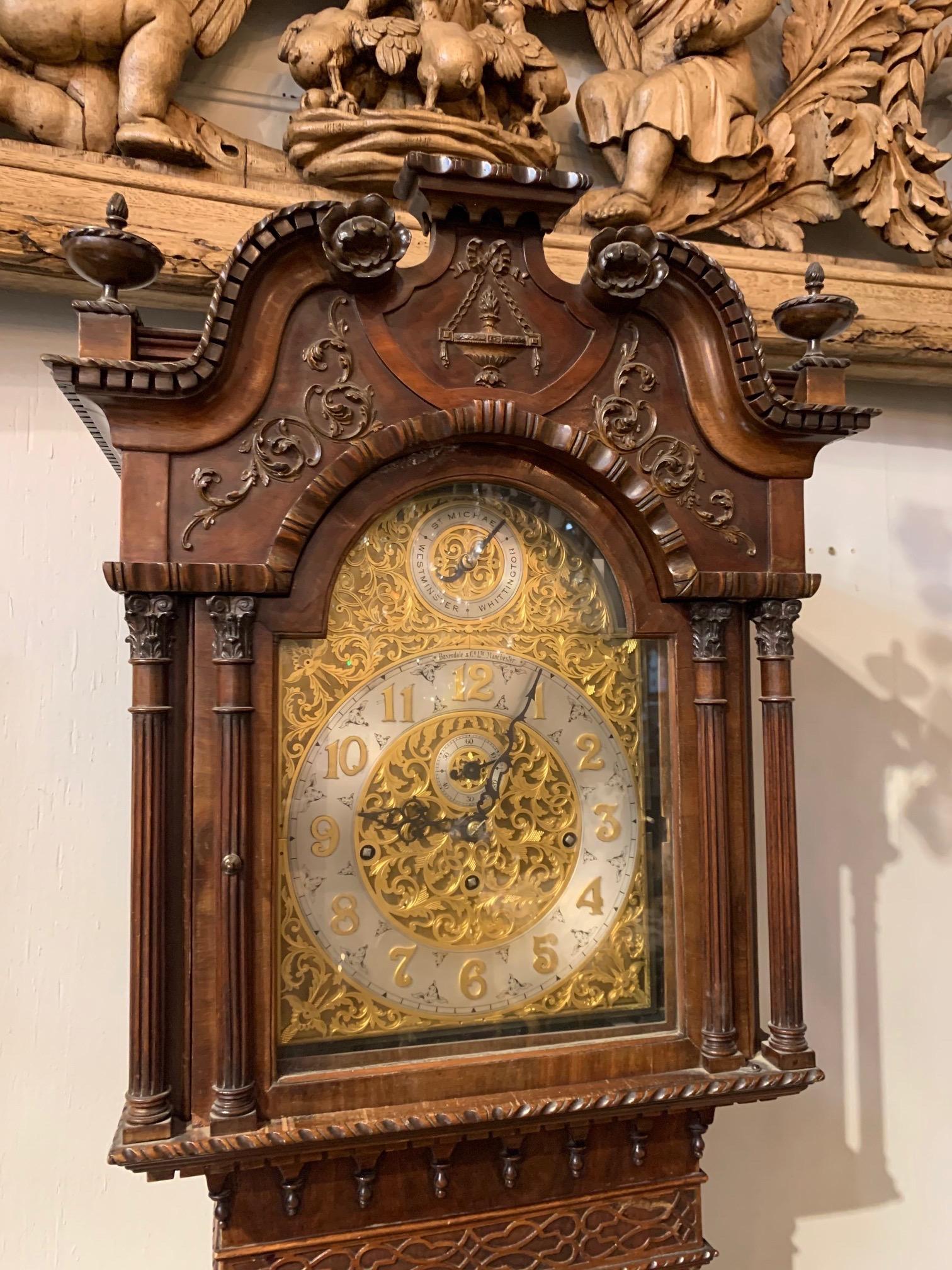 Very fine 19th century English Chippendale long case grandfather clock by Baxondale and Company, Manchester. Exceptional carving and beautiful designs on the clock face. A true work of art!