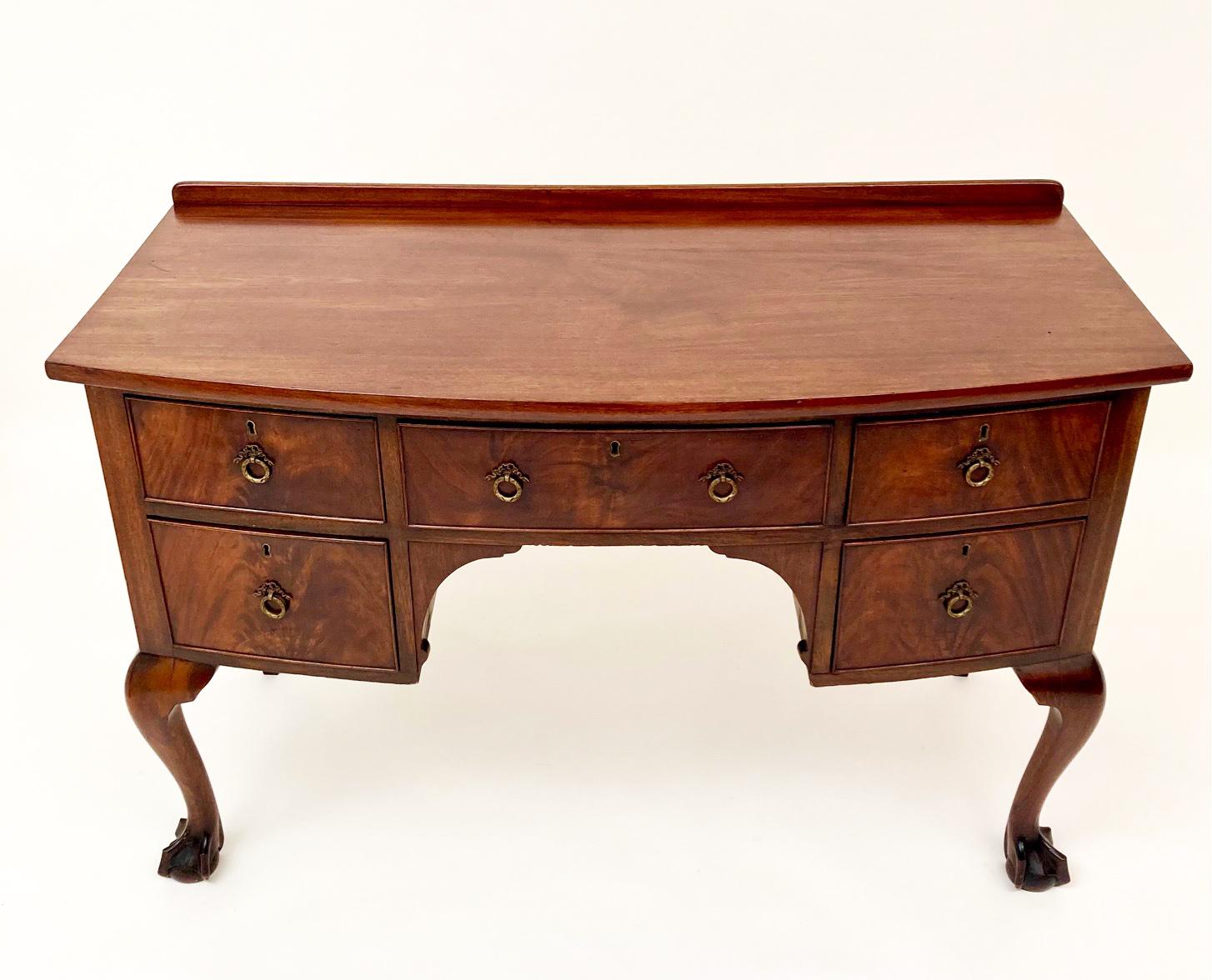 This beautiful English Chippendale small sideboard originated in the 19th century. Made of mahogany and beautifully figured mahogany inlay on the drawer fronts, the front two legs are Chippendale cabriole with heavy ball and claw feet. The drawers