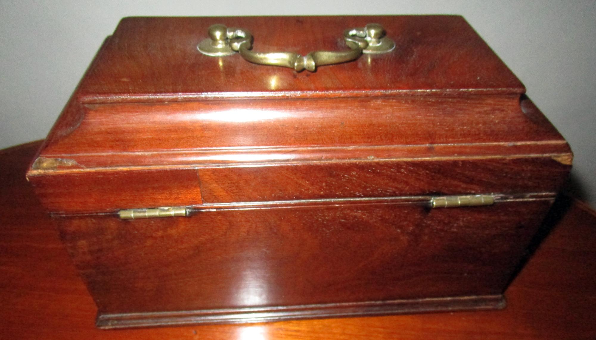 English Chippendale style mahogany box lined with red velvet. Features include original brass escutcheon and top handle. Probably once a tea caddy with lidded interior. Nice old patina. Handsome box for decorative and storage purposes, no tea boxes