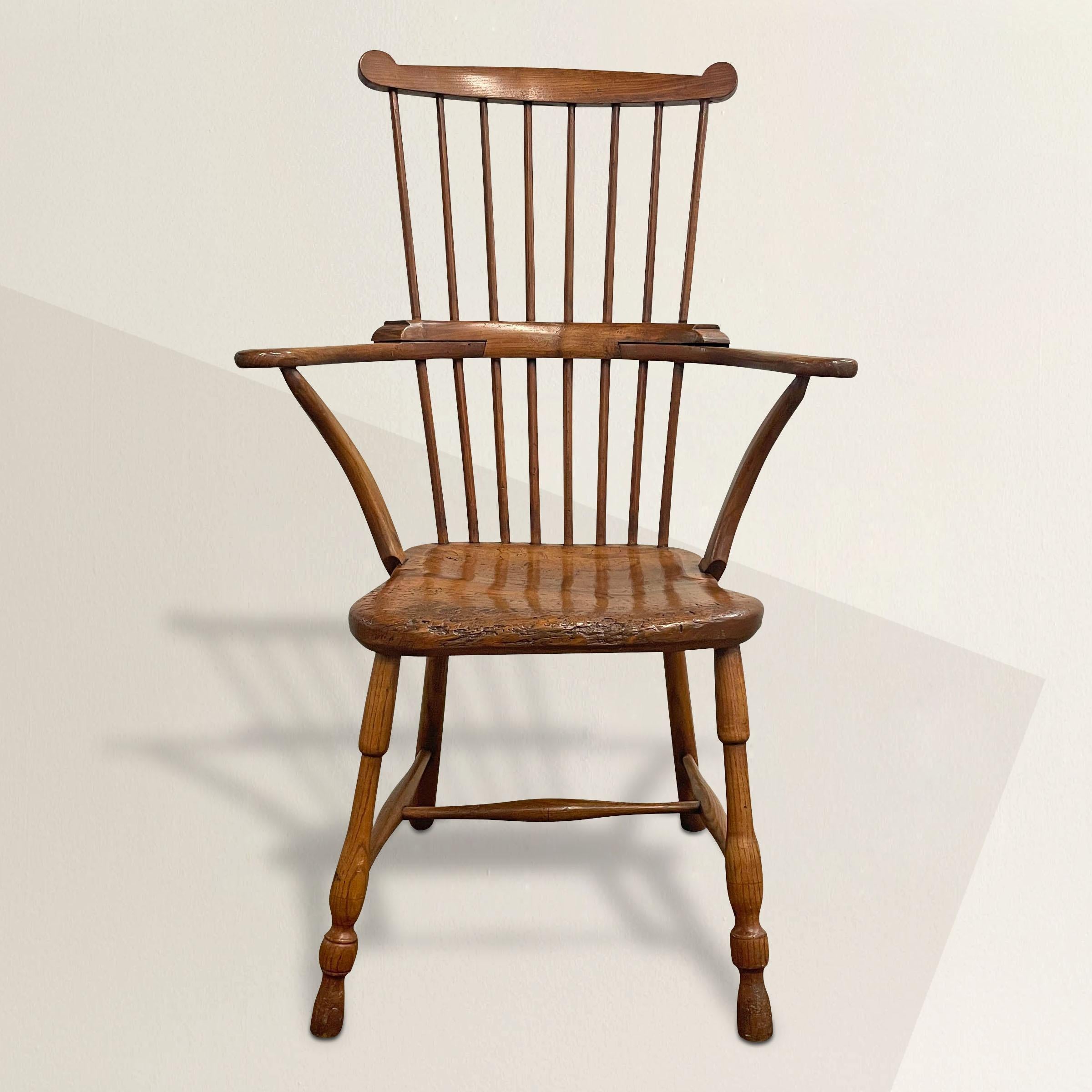 A handsome 19th century English ash and beech comb-back Windsor chair from the Thames Valley, with out-turned arms supported by inverted stretchers, wonderfully turned legs connected by turned stretcher, and a solid beech seat. The seat is one piece