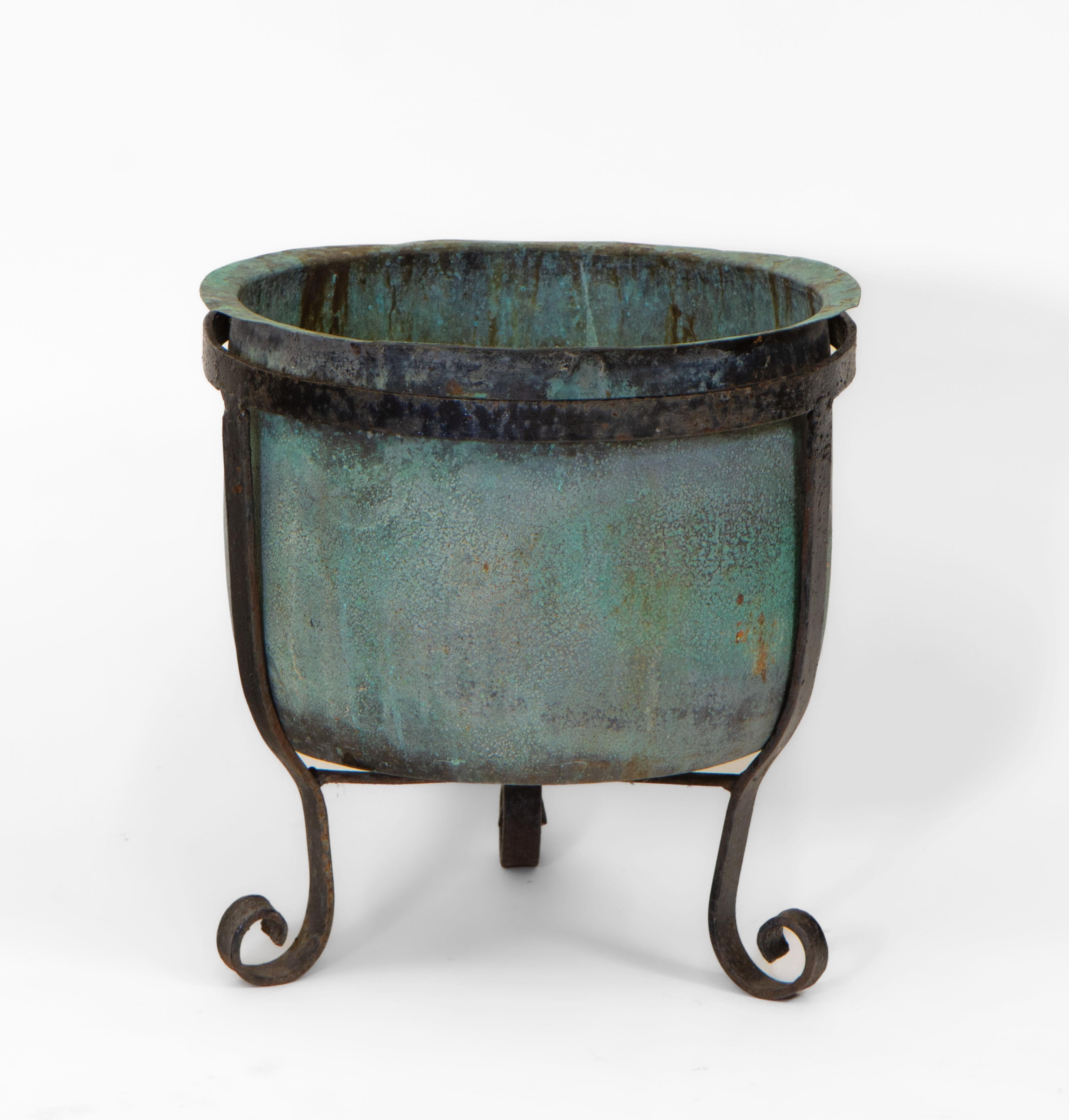 A wonderful English 19th century copper verdigris planter on wrought iron stand with scrolled feet.

UK delivery included.

The pot showing lovely natural verdigris patina, weathered, slightly misshapen. Structural very sound it has no drainage