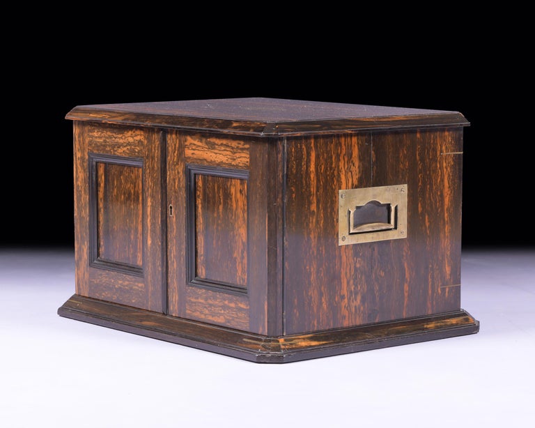 An exquisite 19th century Coromandle canteen service by Walker & Hall. Of rectangular form fitted with recessed brass side handles, and twin panel doors enclosing a fitted interior with four shallow drawers retaining a Hanoverian rat-tail service