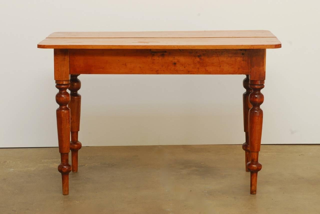 Rustic 19th century English country farmhouse constructed from mixed woods. Two panel plank top supported by large turned legs. Simple farmhouse style work table with many uses and a rich vintage patina.