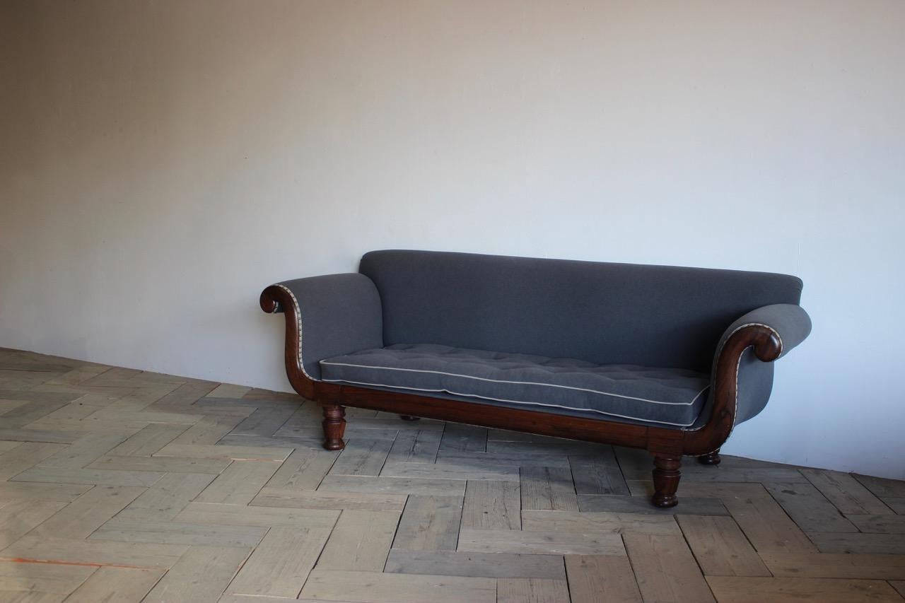 A 19th English country house rosewood sofa of good proportions and quality, retaining the original castors, having been reupholstered by us in wool. 

George IV, circa 1825.

Measurements: 47cm High (floor to seat).