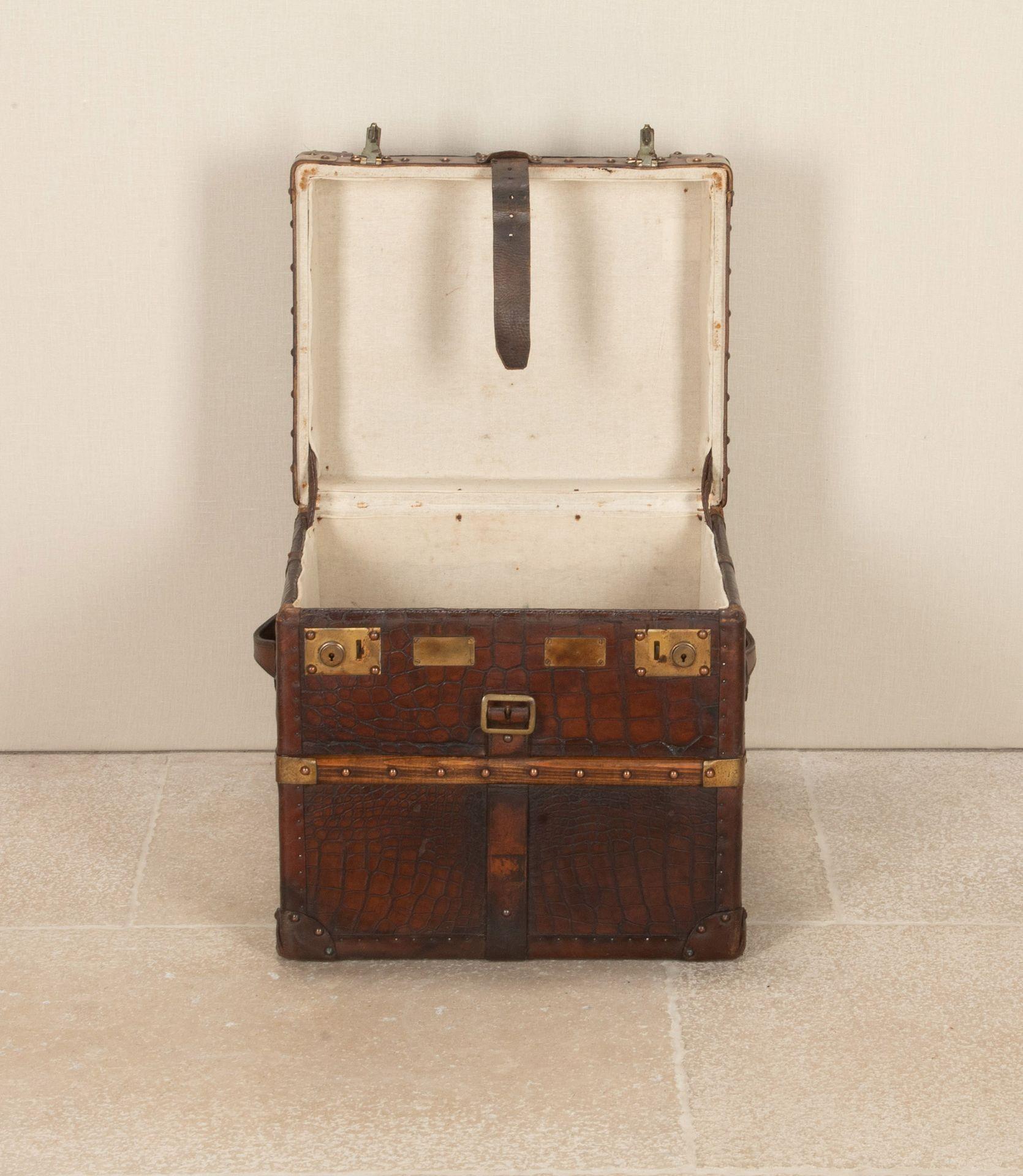 Stunning 19th Century English crocodile leather trunk. In lovely condition and deep patination consistent decades of polishing and age. Remains of antique G.W.R (Great Western Rail). Collected Luggage Label. With copper studs and brass banding.