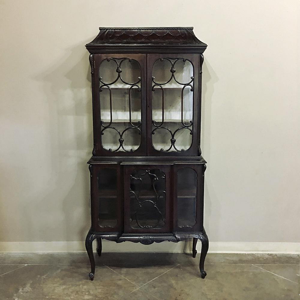 Ideal for displaying your special collection or family heirlooms, this 19th century English Curio cabinet displays the influence of the so-called hand-carved 
